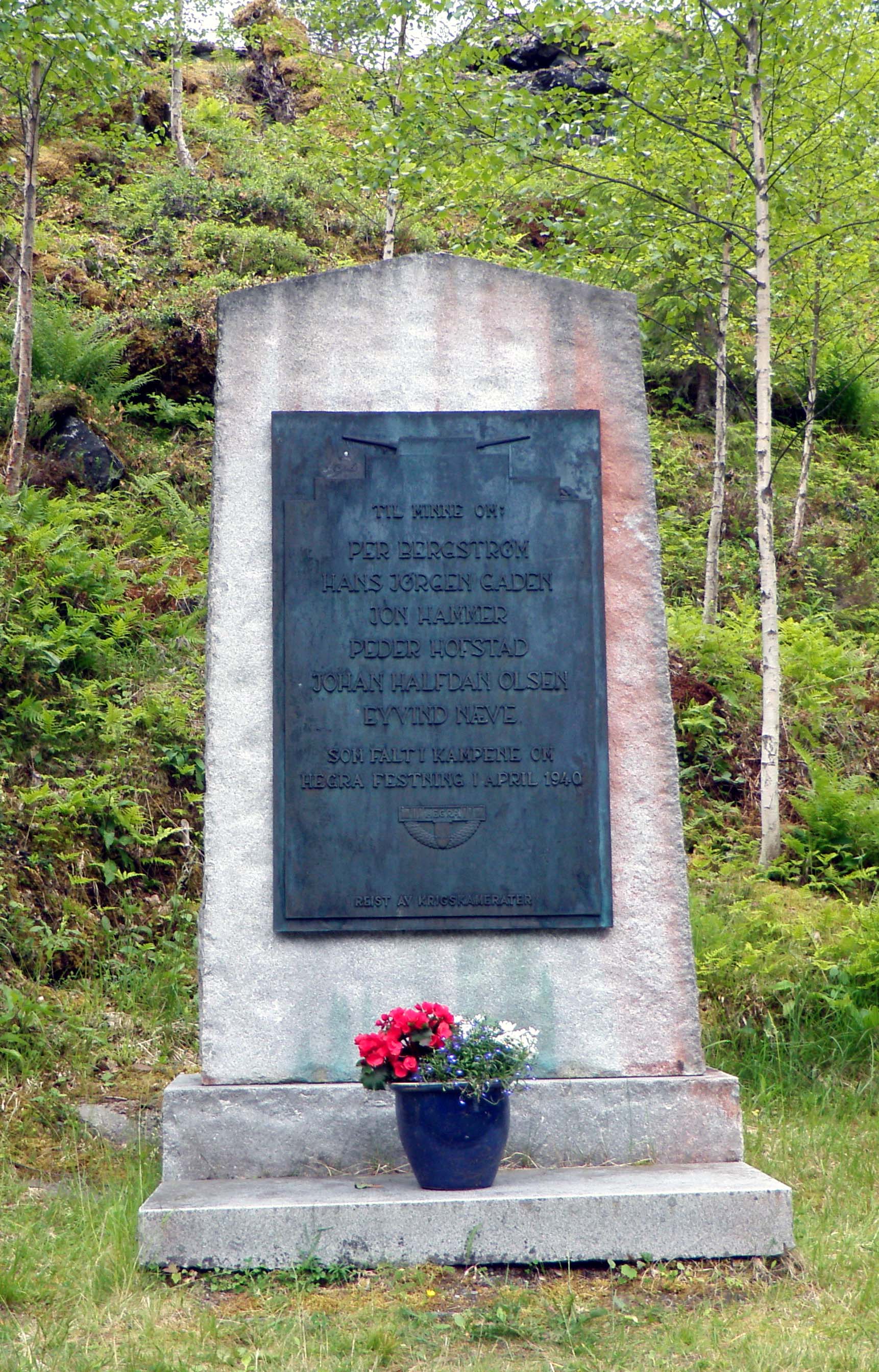 Memorial plaque in memory of the six Norwegian soldiers who were killed in the April-May 1940 Battle of Hegra Fortress, raised by fellow veterans of the battle. The memorial is located next to the entrance gate to Hegra Fortress, in Hegra, Norway.