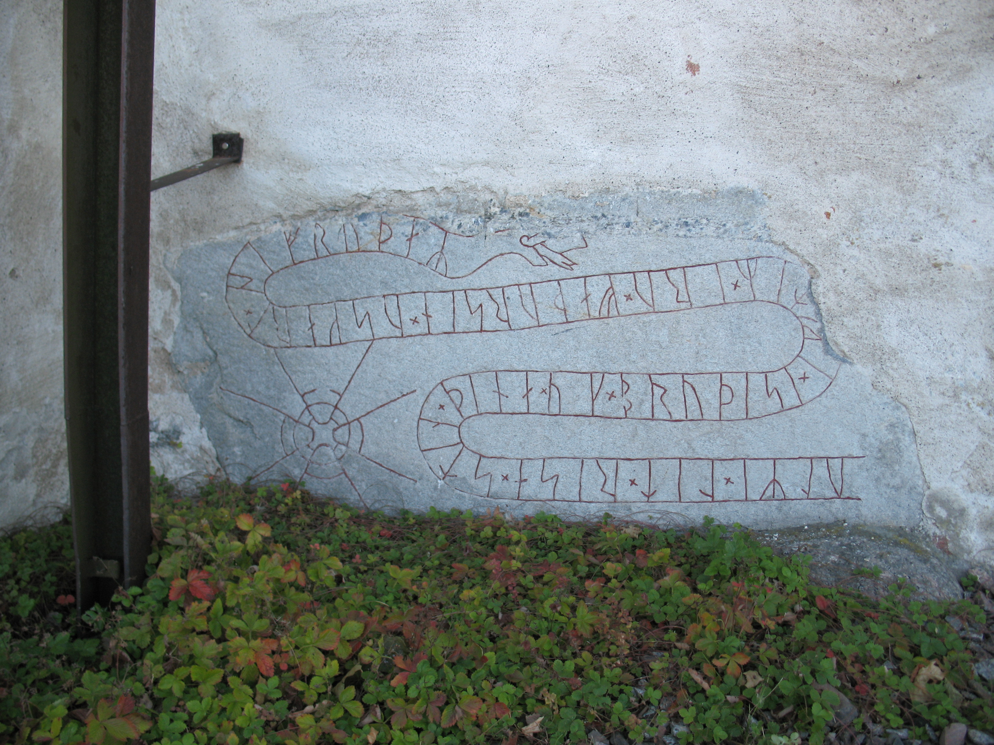 Runestone U 335 at the church of Orkesta, Vallentuna municipality.