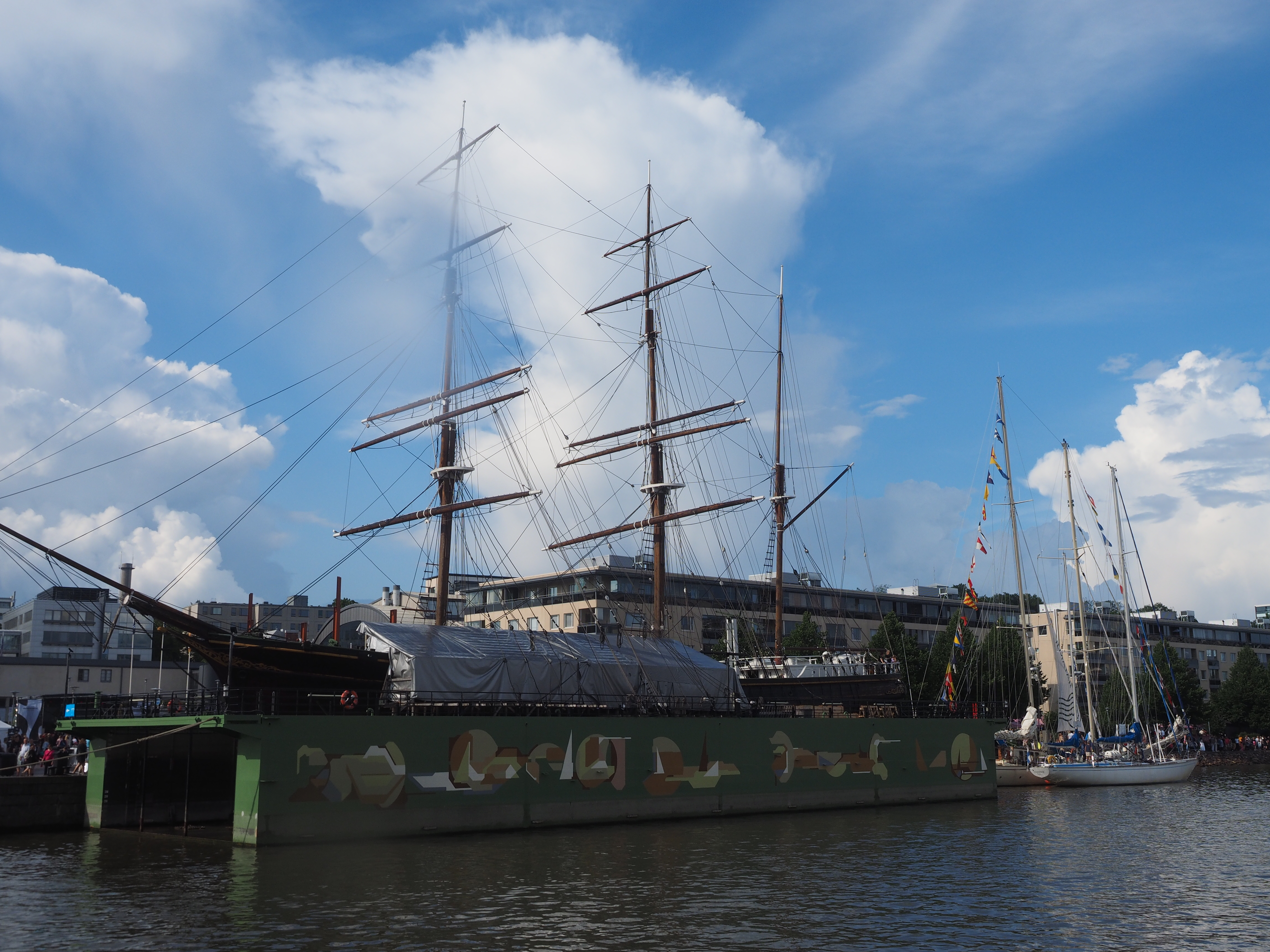 The ship Sigyn on the River Aura in central Turku, Finland on an evening in July 2024. The ship is actually not floating on the River Aura itself, but instead rests on a mobile dock that is in turn floating on the river.