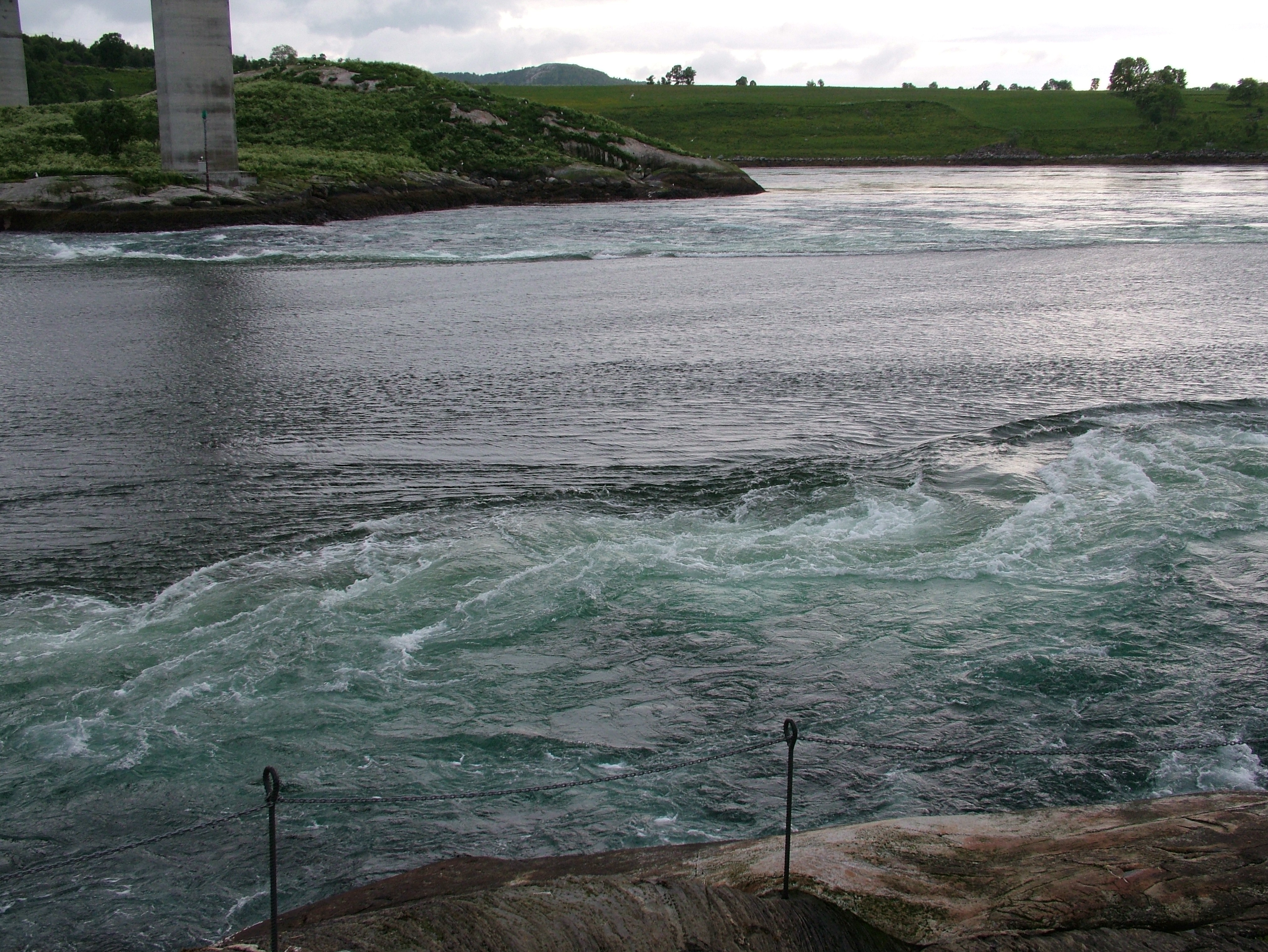 The tidal current at Saltstraumen, near Bodø, Norway, in June 2005. Two piers of the highway 17 bridge are visible on the far side.