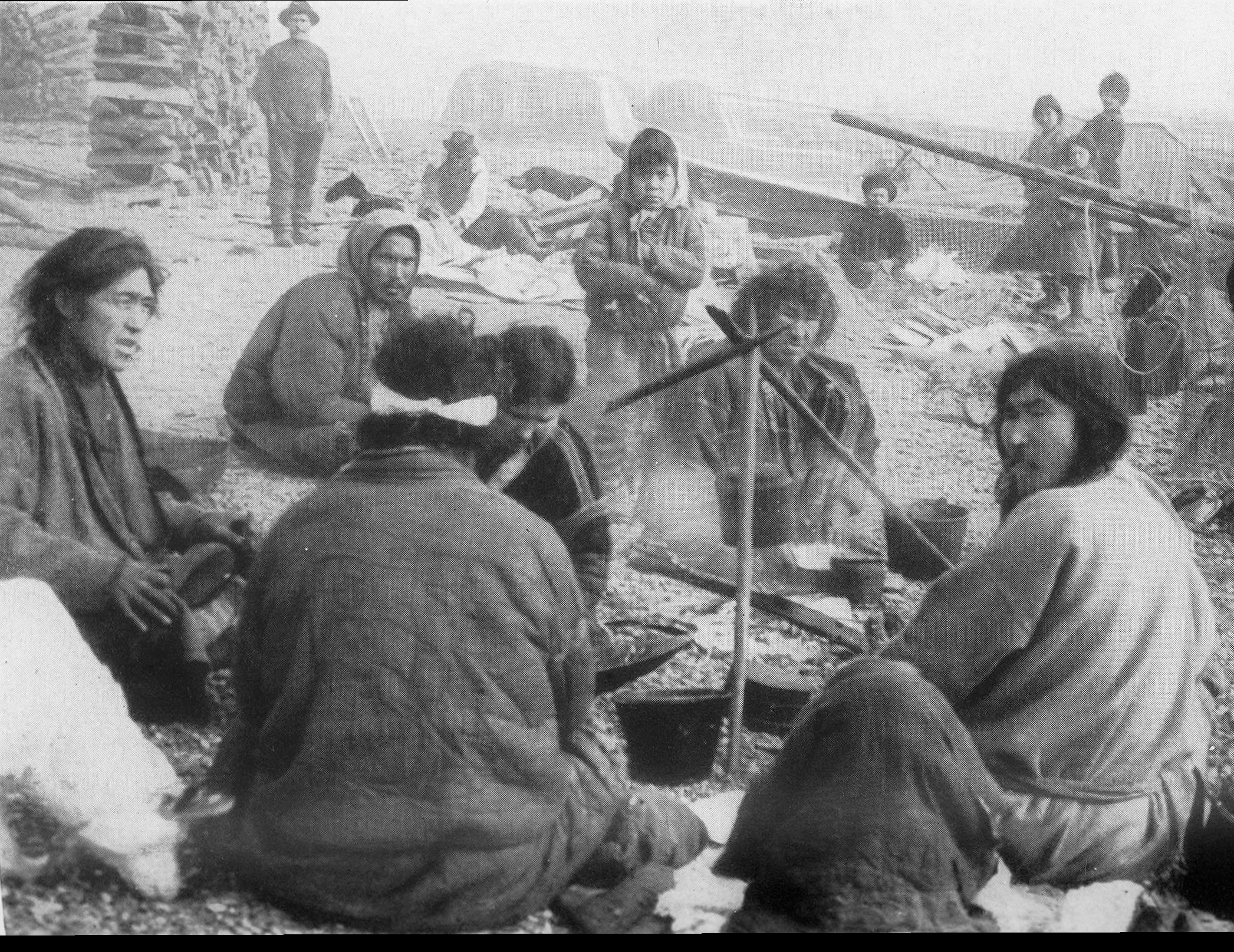 1913 photograph of Ket people around a campfire.