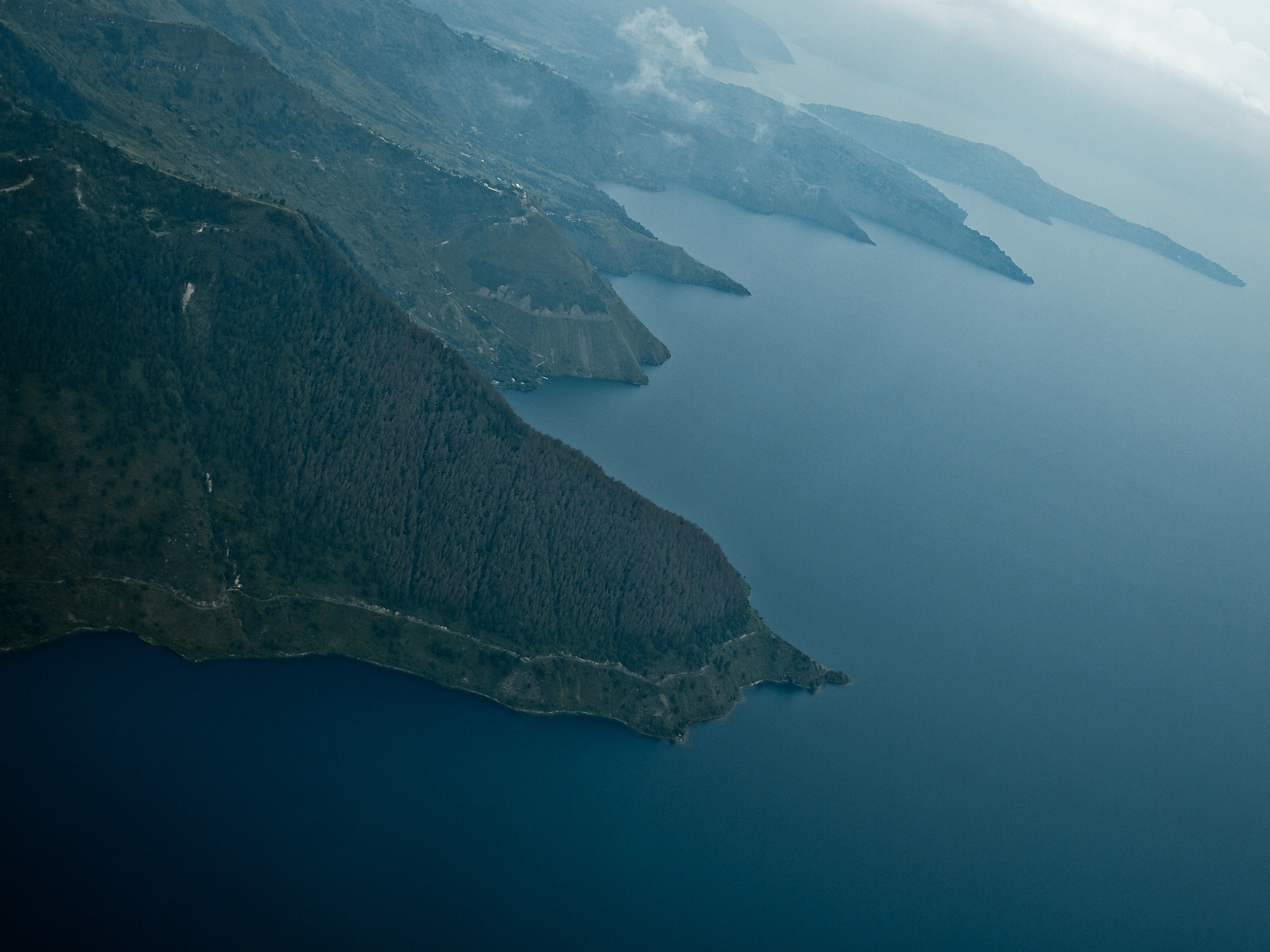 Approach to Silangit Airport, southern shore of Danau Toba (Lake Toba), with Pulau Sibandang (Sibandang Island) visible in the background.