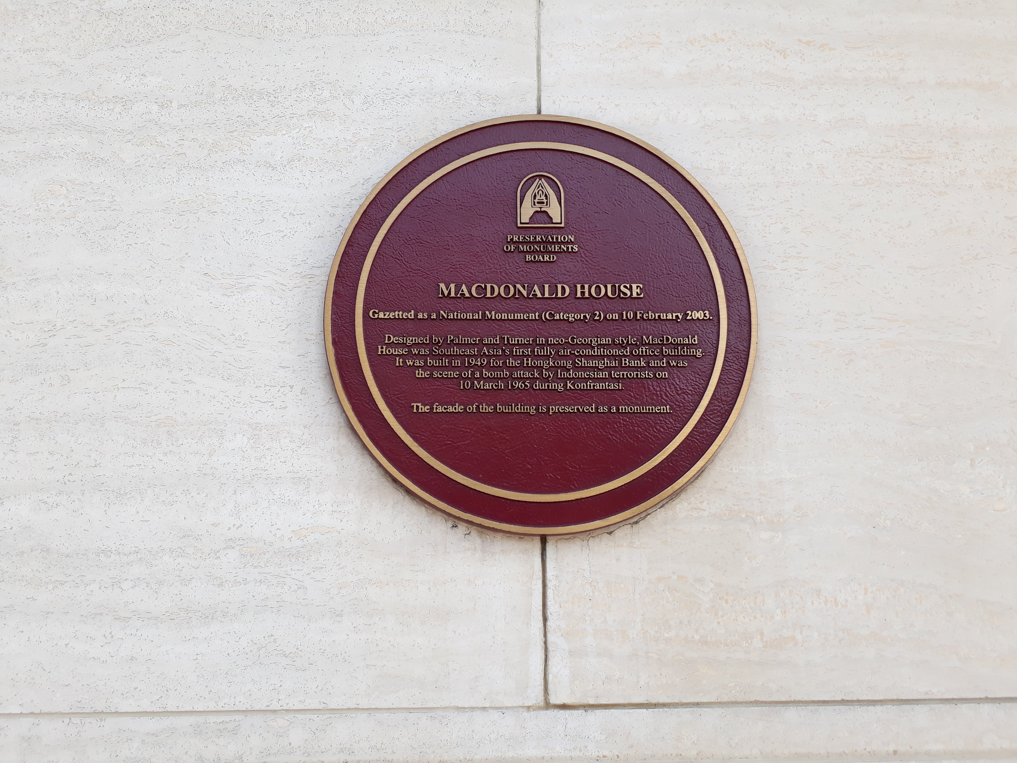 The plaque on the front of MacDonald House, Singapore, commemorating the 1965 bombing