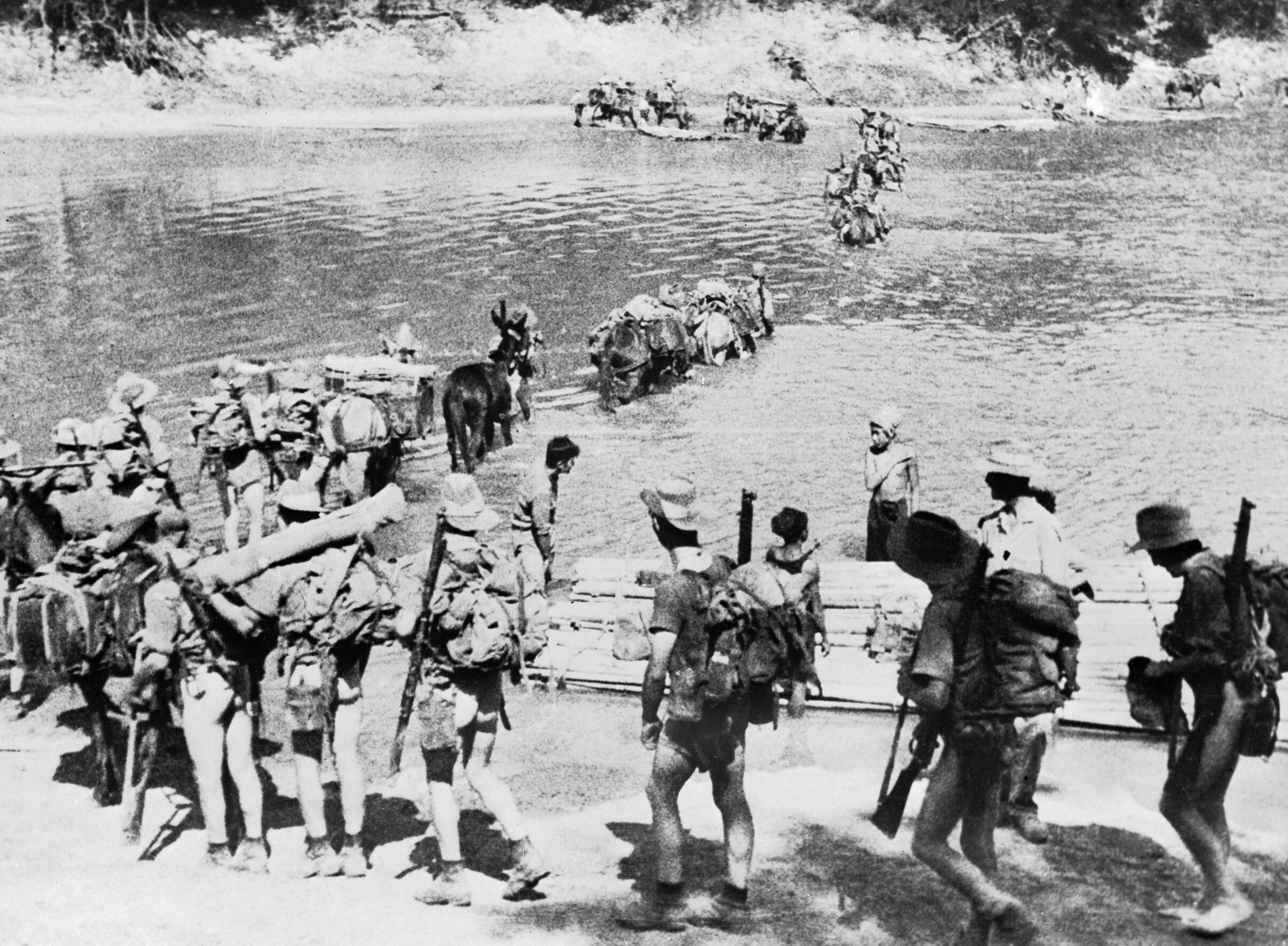IWM caption : THE CHINDITS. Chindit Operations - General: A Chindit column crossing a river in Burma, 1943.