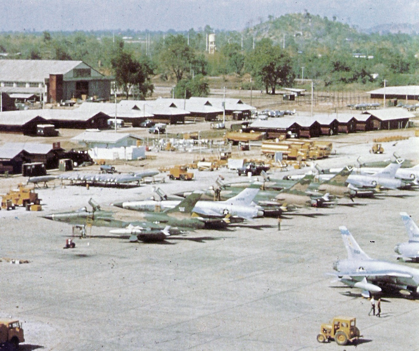 Republic F-105D Thunderchief fighter-bombers of the U.S. Air Force 4th Tactical Fighter Wing at Takhli Royal Thai Air Force Base, Thailand, in December 1965. Note that the F-105s are in the process of being camouflaged. The first plane on the left carries a AIM-9B Sidewinder air-to-air missile on its left outer wing pylon.