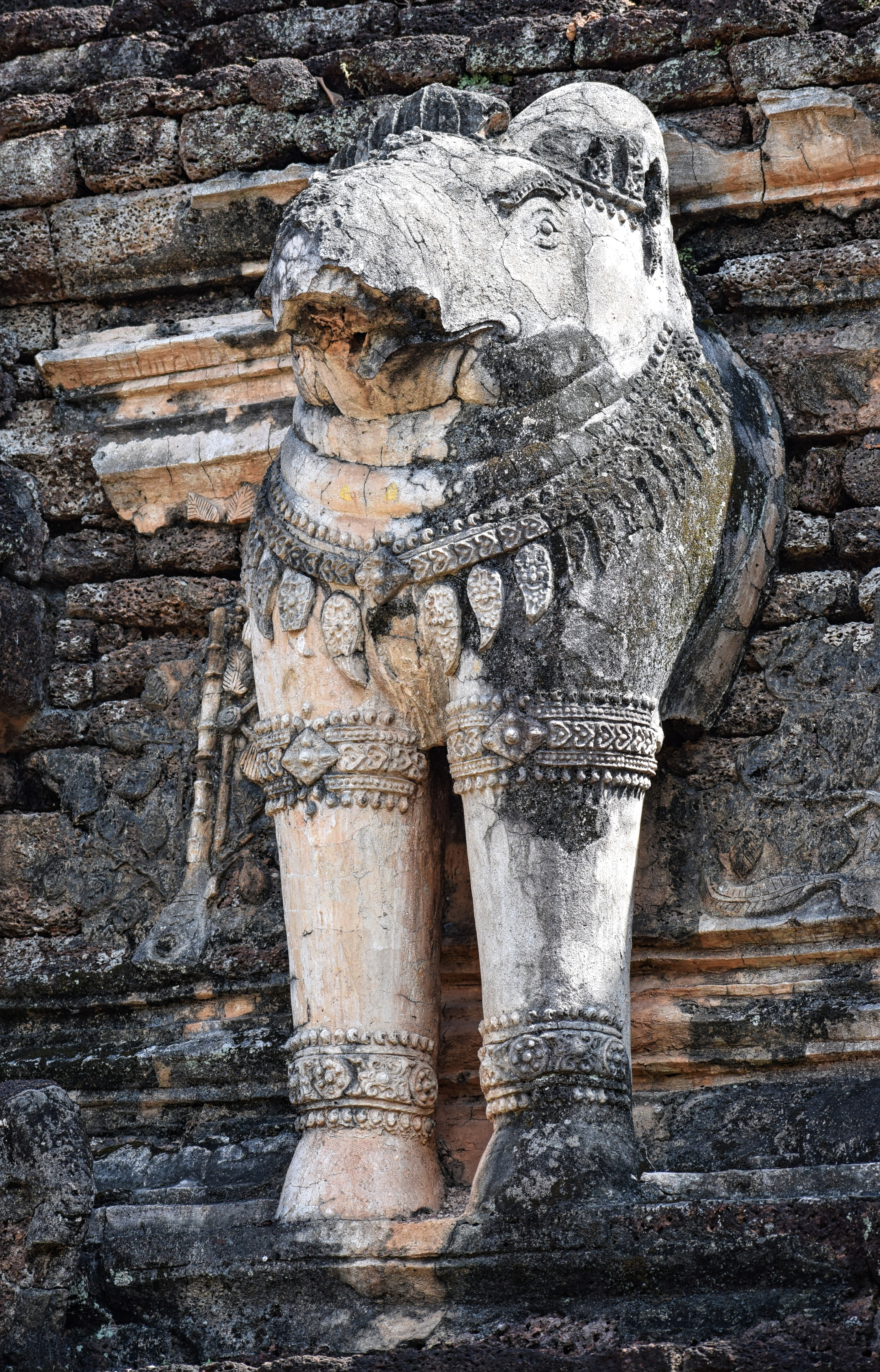 Wat Chang Rob in the Kamphaeng Phet Historical Park, Kamphaeng Phet Province, Thailand. All of the elephants at Wat Chang Rob have lost their trunks. "Chang" is the Thai word for elephant and it is pronounced "Chong".