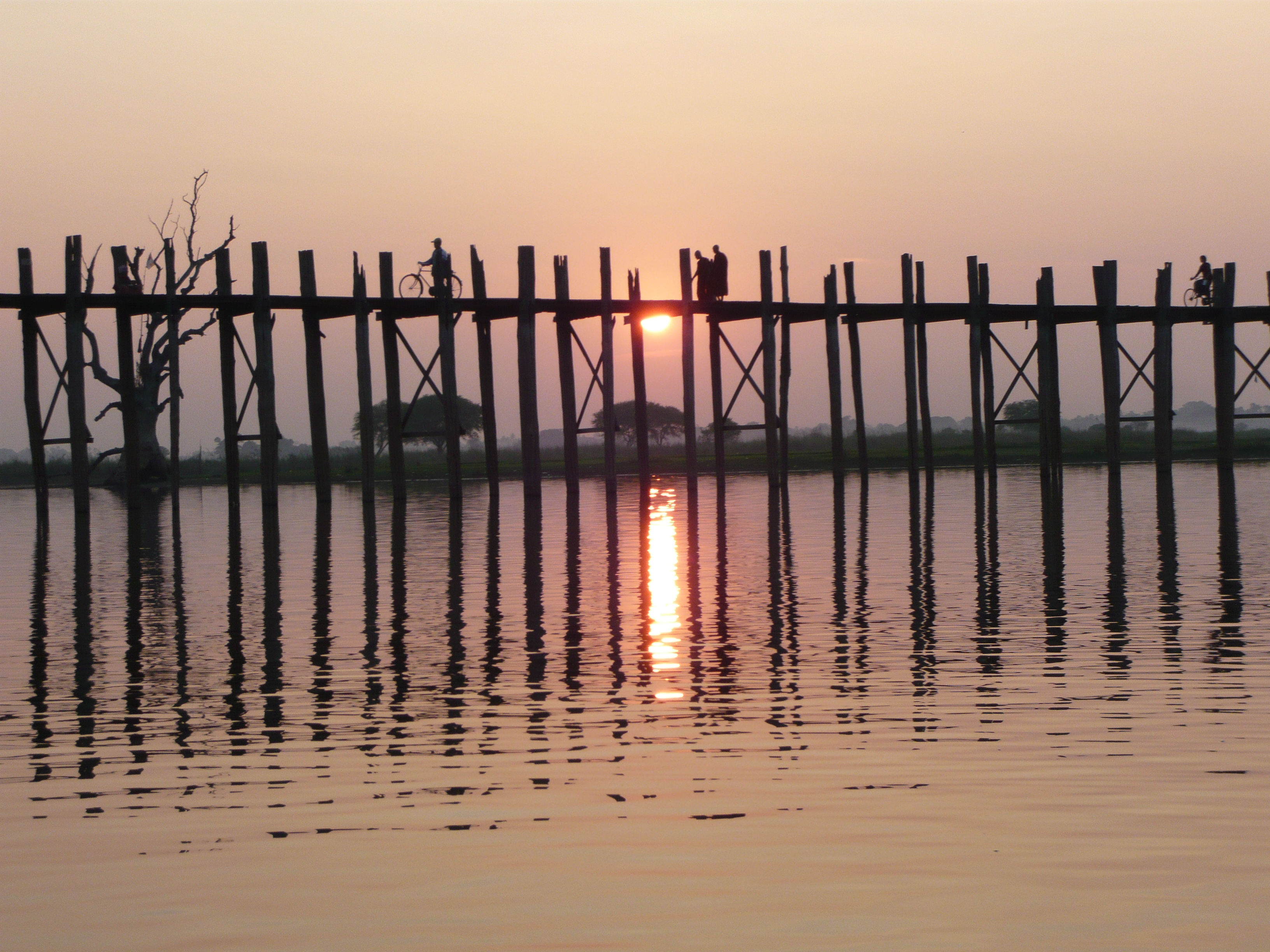 Monks crossing bridge at sunset
I took this picture on vacation in December 2007.
Removed from the following pages:

Amarapura
--OrphanBot (talk) 10:21, 20 February 2008 (UTC)