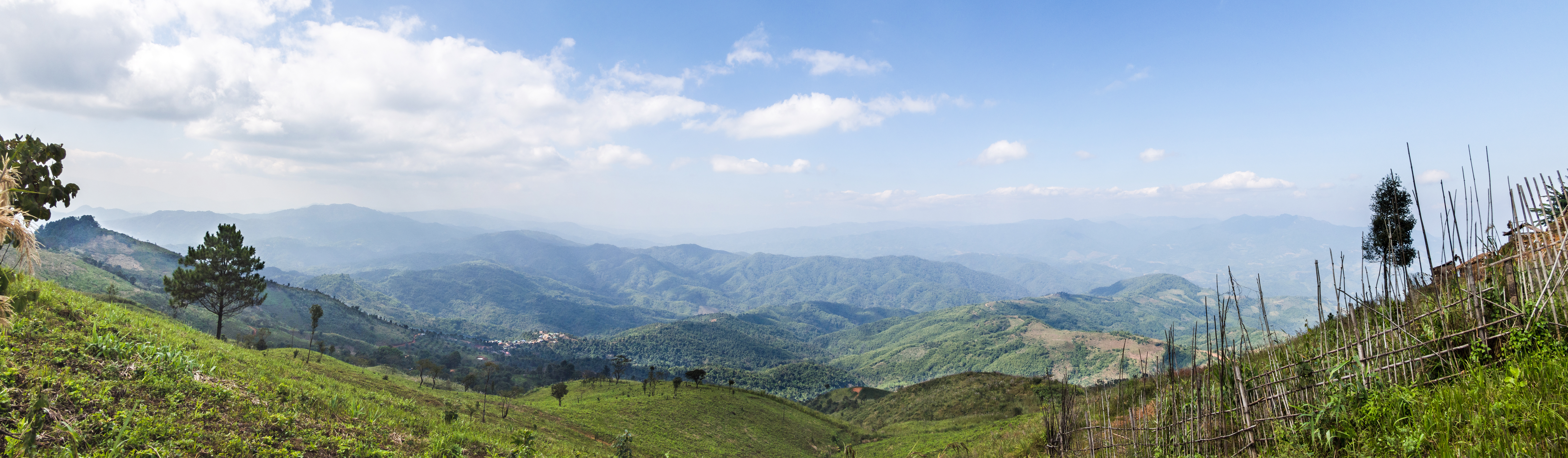 Looking out over Tachileik District, Shan State, Burma, into the heart of the Daen Lao Range from Thai road number 1149 in Mae Sai District, which runs partway along the border with Burma. Technically, I was standing inside Burma, if only by about 1 meter, when I made the images used in this panorama.
 This  image was created with Hugin.