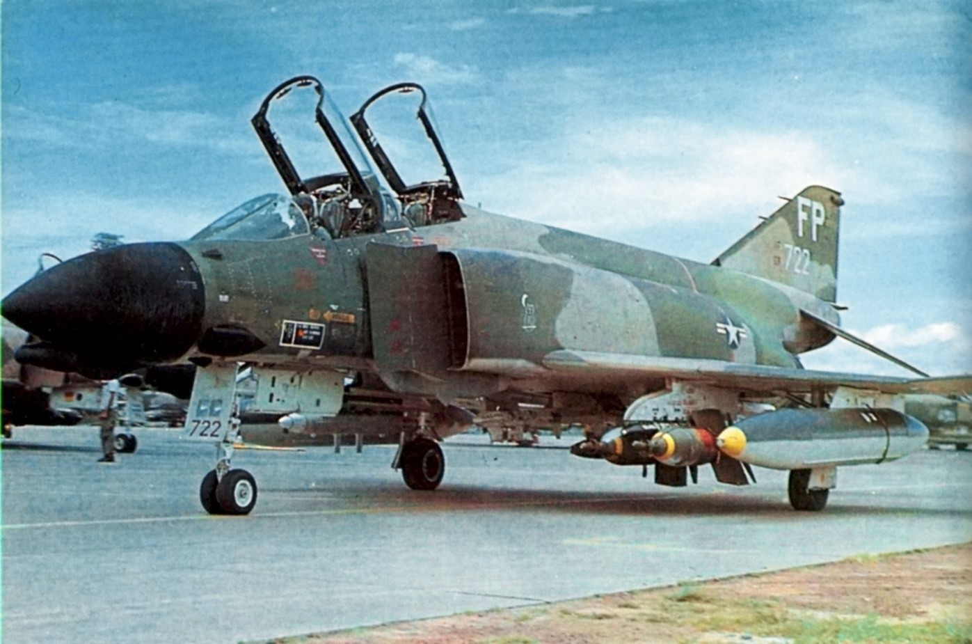 A U.S. Air Force McDonnell F-4D Phantom II from the 497th Tactical Fighter Squadron, 8th Tactical Fighter Wing, taxies at Ubon Royal Thai Air Force base in 1971. The aircraft is armed with two BOLT-117 (BOmb, Laser Terminal-117). The BOLT-117 was later redesignated as the GBU-1/B (Guided Bomb Unit) and was the world's first laser guided bomb. The aircraft and carries a AN/ALQ-72 jamming pod under the wings, and a strike camera in the forward left missile bay.