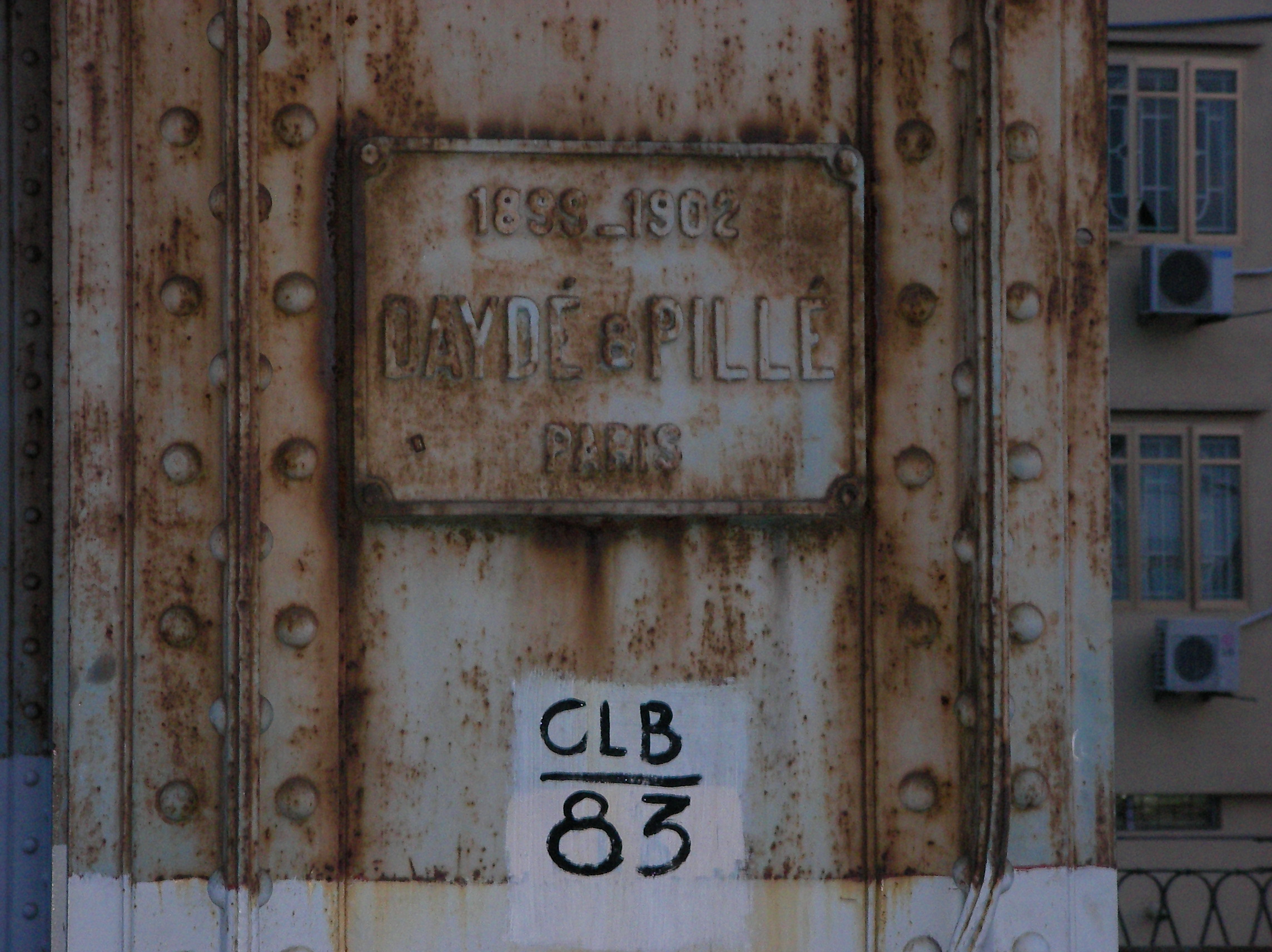 A panel on Long Bien bridge showing the name of its contructor.