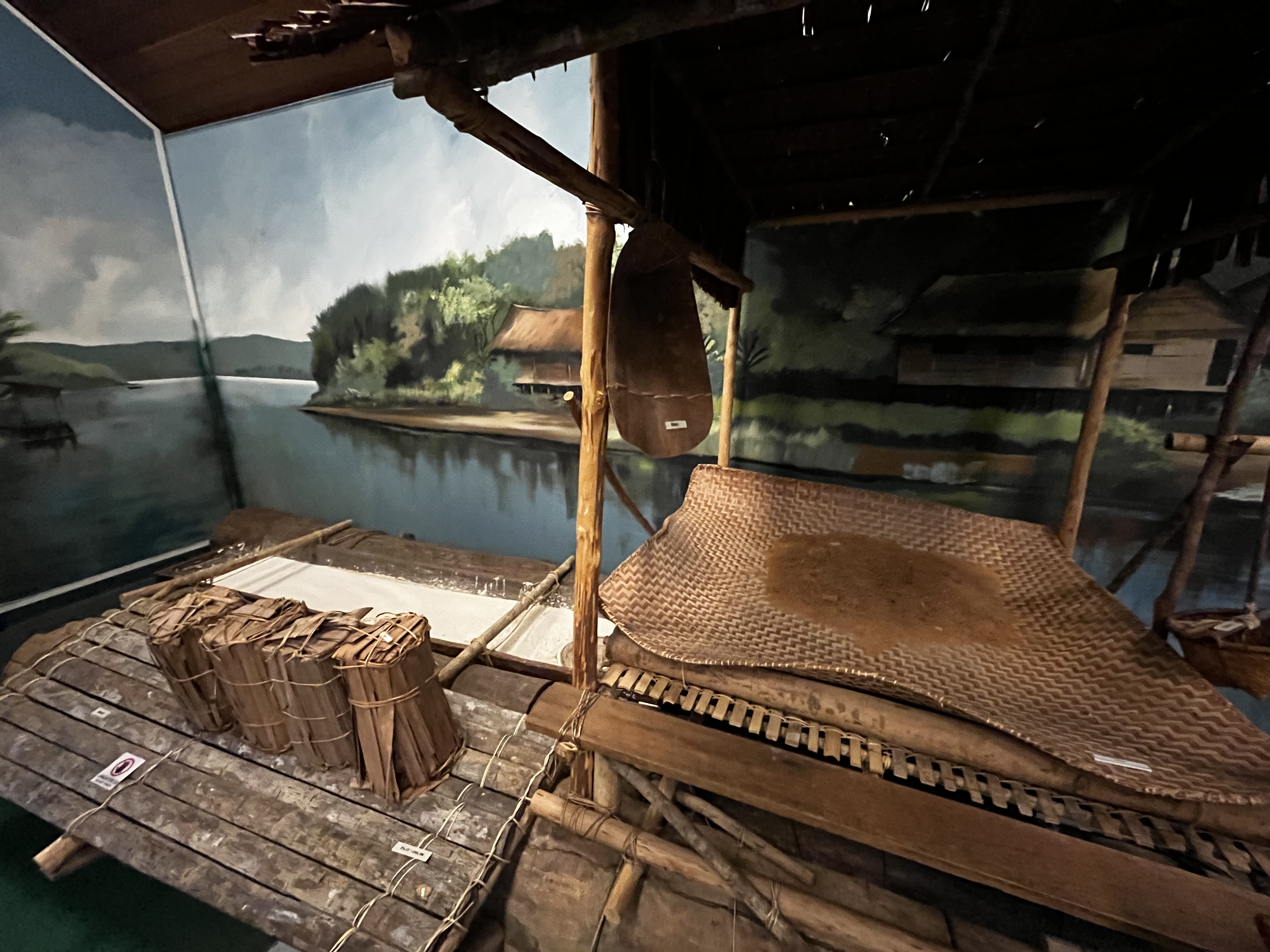 Image depicting the exhibit at the Malay Technology Museum in Kota Batu, Brunei. Showcasing traditional Malay technologies such as salt making, boat building, traditional housing architecture, and weaving.
