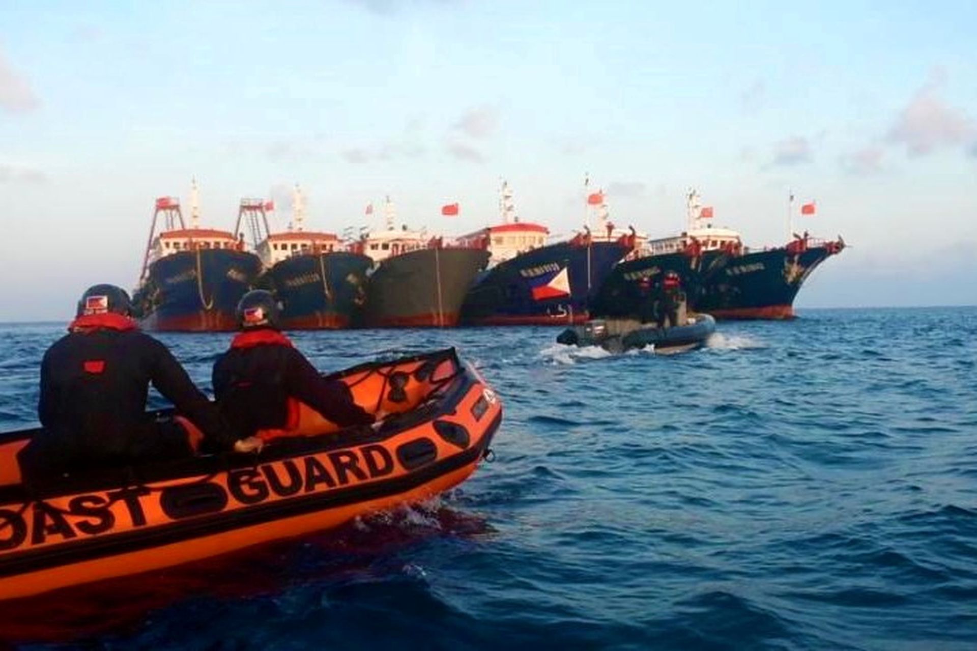 The BRP Cabra of the Philippine Coast Guard and two vessels of the Bureau of Fisheries and Aquatic Resources approaches Chinese-flagged ships at Whitsun Reef (known as Julian Felipe Reef in the Philippines) on April 13, 2021 during maritime patrol operations.