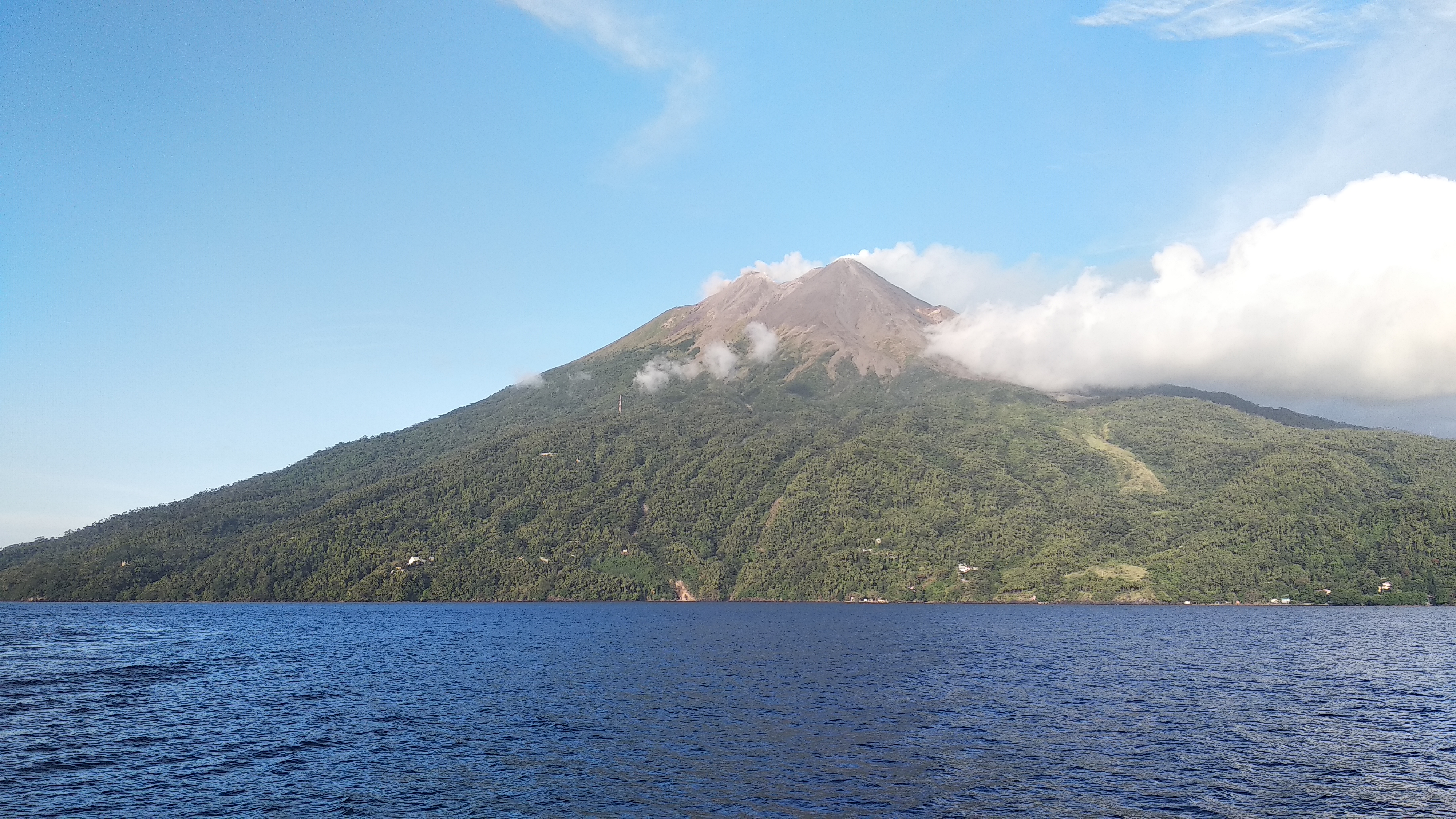 The peak of Mount Karangetang is seen from the western side of the island of Siau.