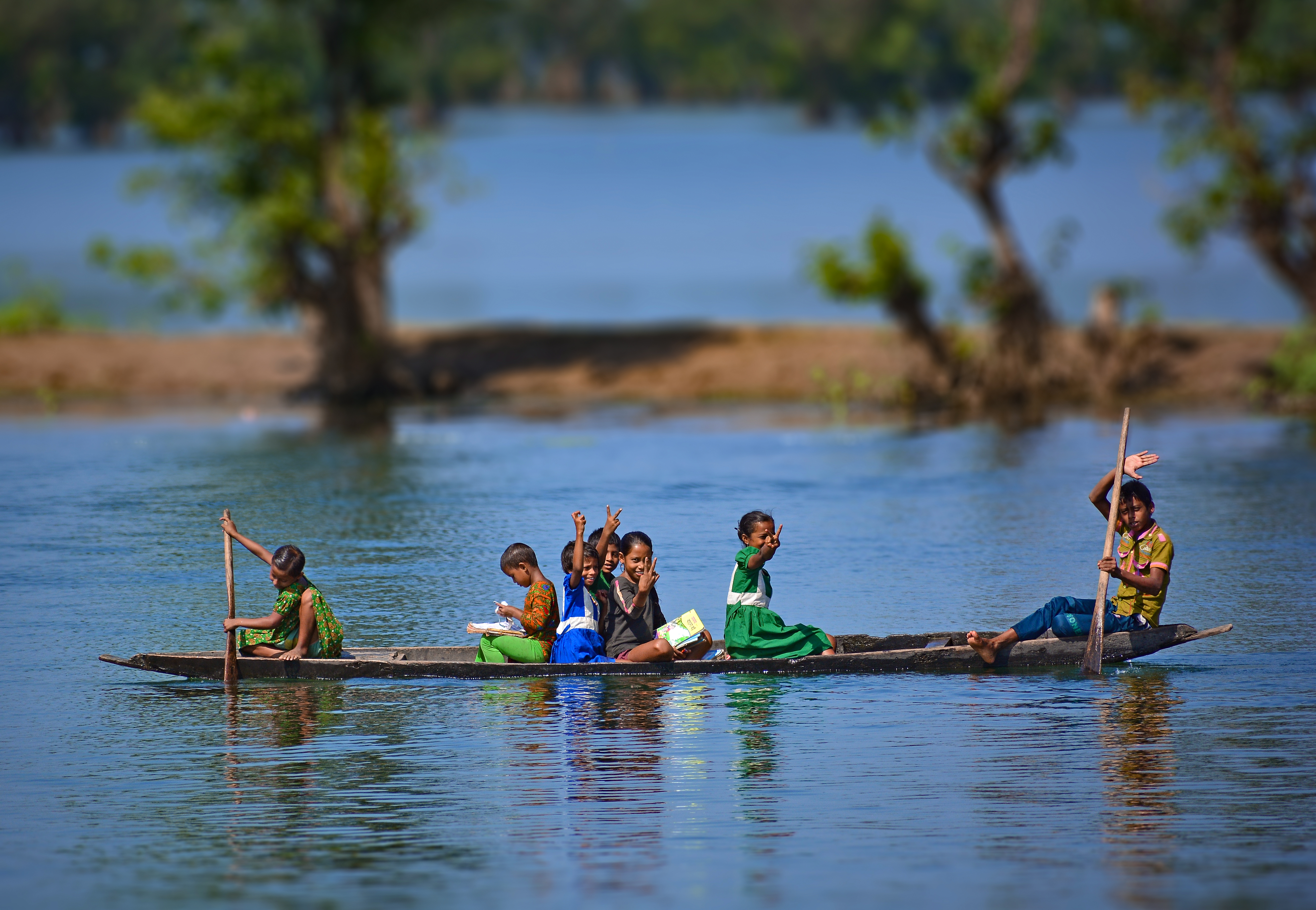 Children in a boat on the Shari-Goyain River in Ratargul Swamp Forest, Bangladesh