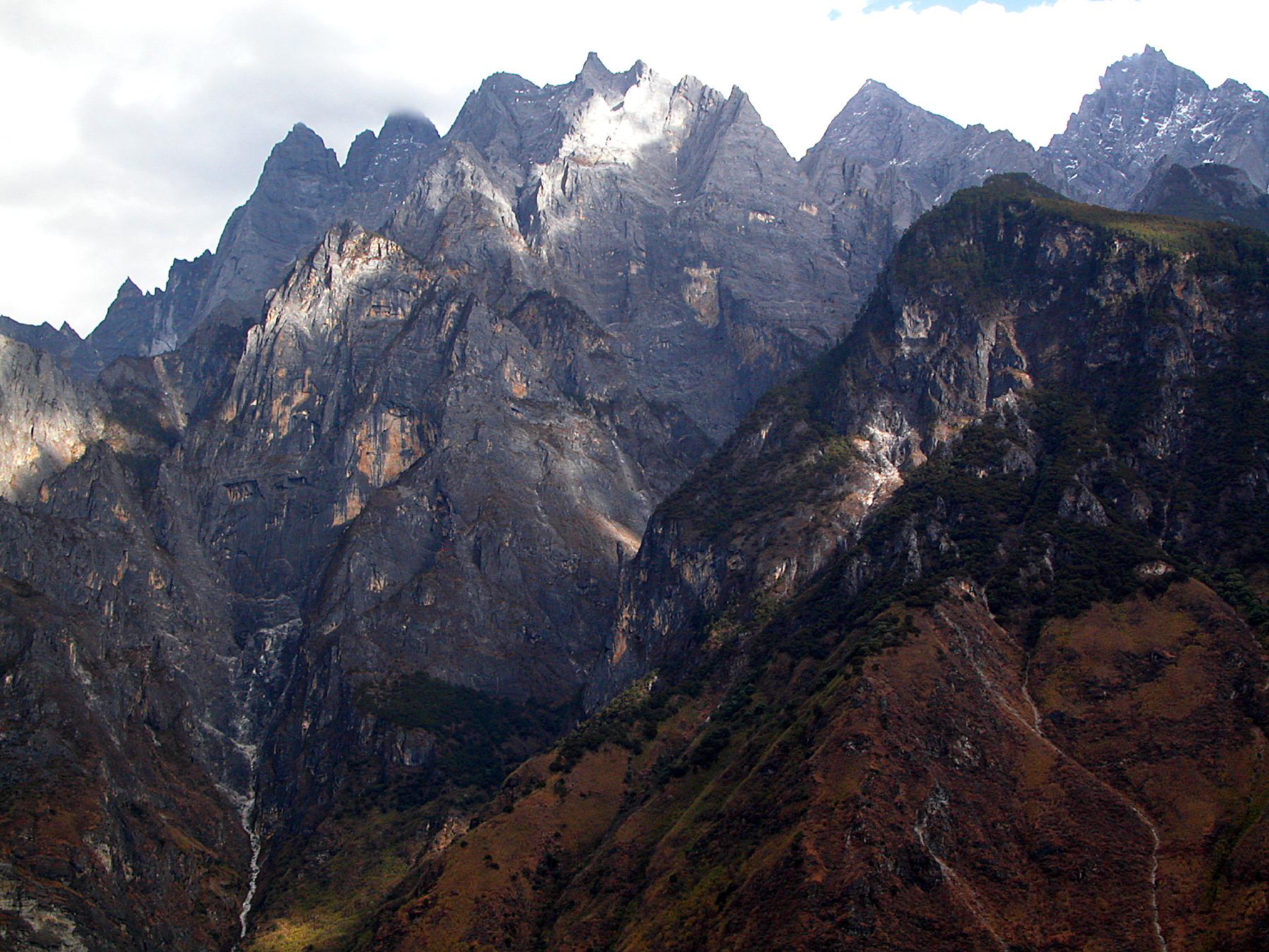 Afternoon light on the jagged grey mountains rising from the Yangzi River gorge, in south-western China's Yunnan ProvinceAfternoon Light