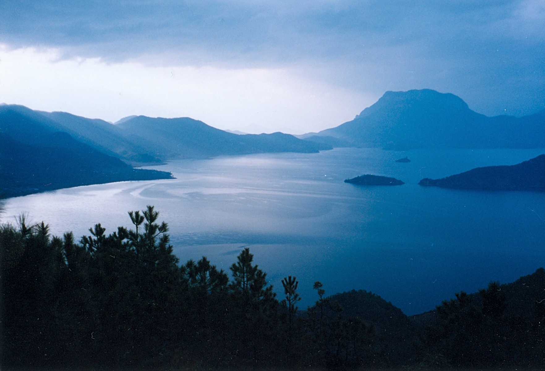 Lugu Lake, Yunnan, China. In the background on top of the right hand side of the lake you can see the holy mountain Ganmu.