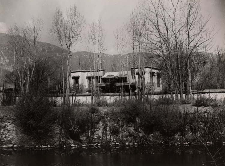 View of the Dekyi Lingka, the residence of the British Mission in Lhasa, set amongst trees in the grounds belonging to Kundeling Monastery