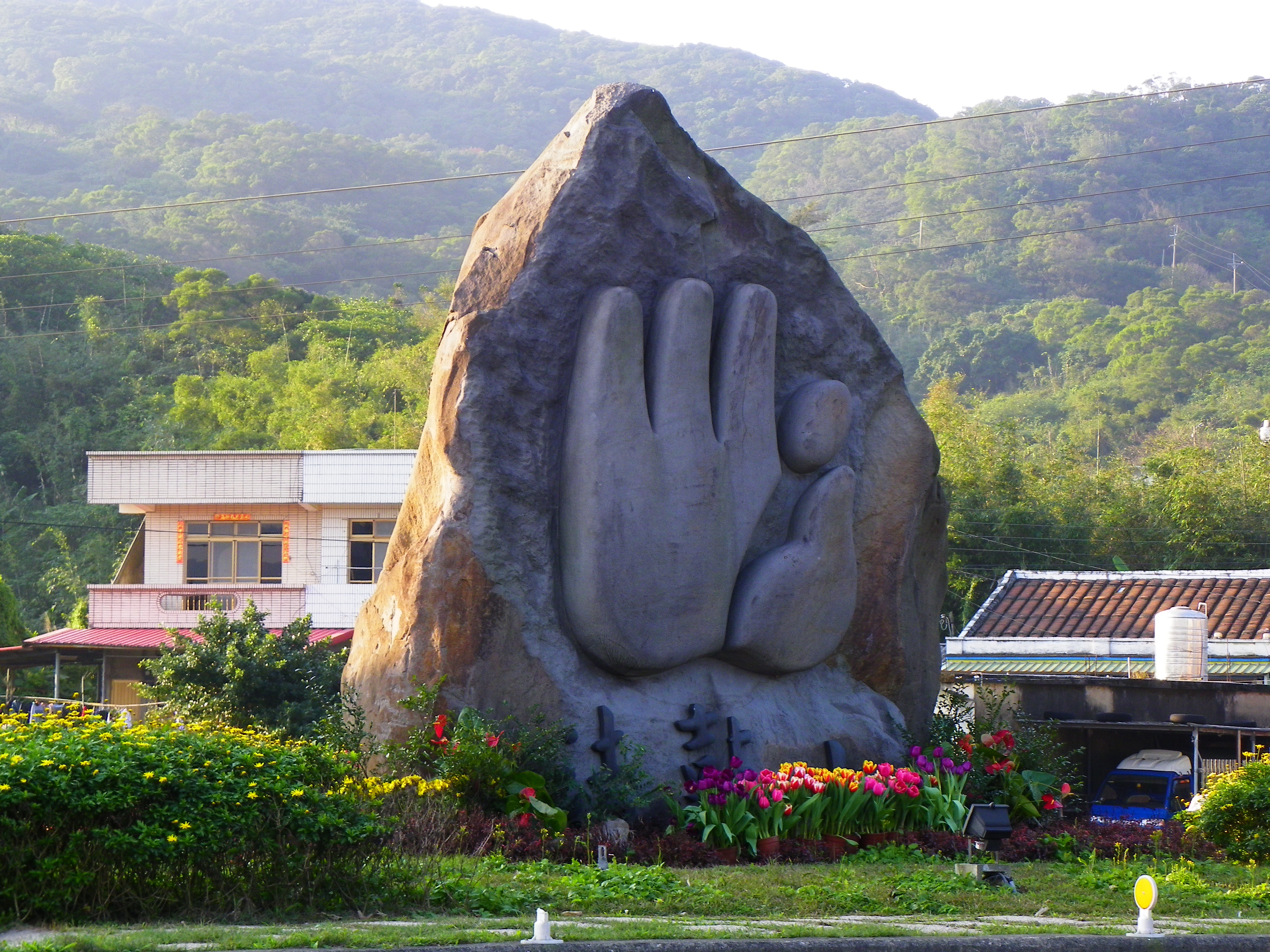 ​法鼓山入山道路口的山徽石，圖形源自佛陀轉法輪時的說法印。