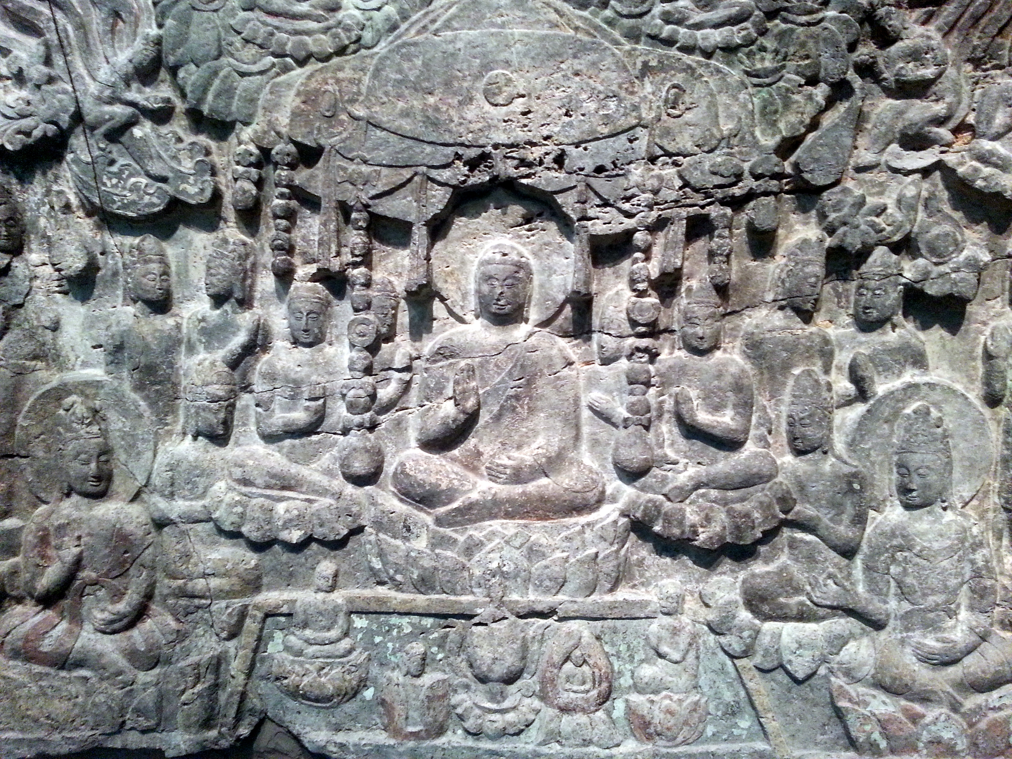 Photograph of a relief showing the western paradise of the Amitabha buddha from Cave 2 of the Xiangtangshan Caves at the Freer Gallery of Art, Smithsonian Institution, Washington, DC. The relief dates from the Northern Qi dynasty (550-577), it carved in limestone and shows traces of pigment.
