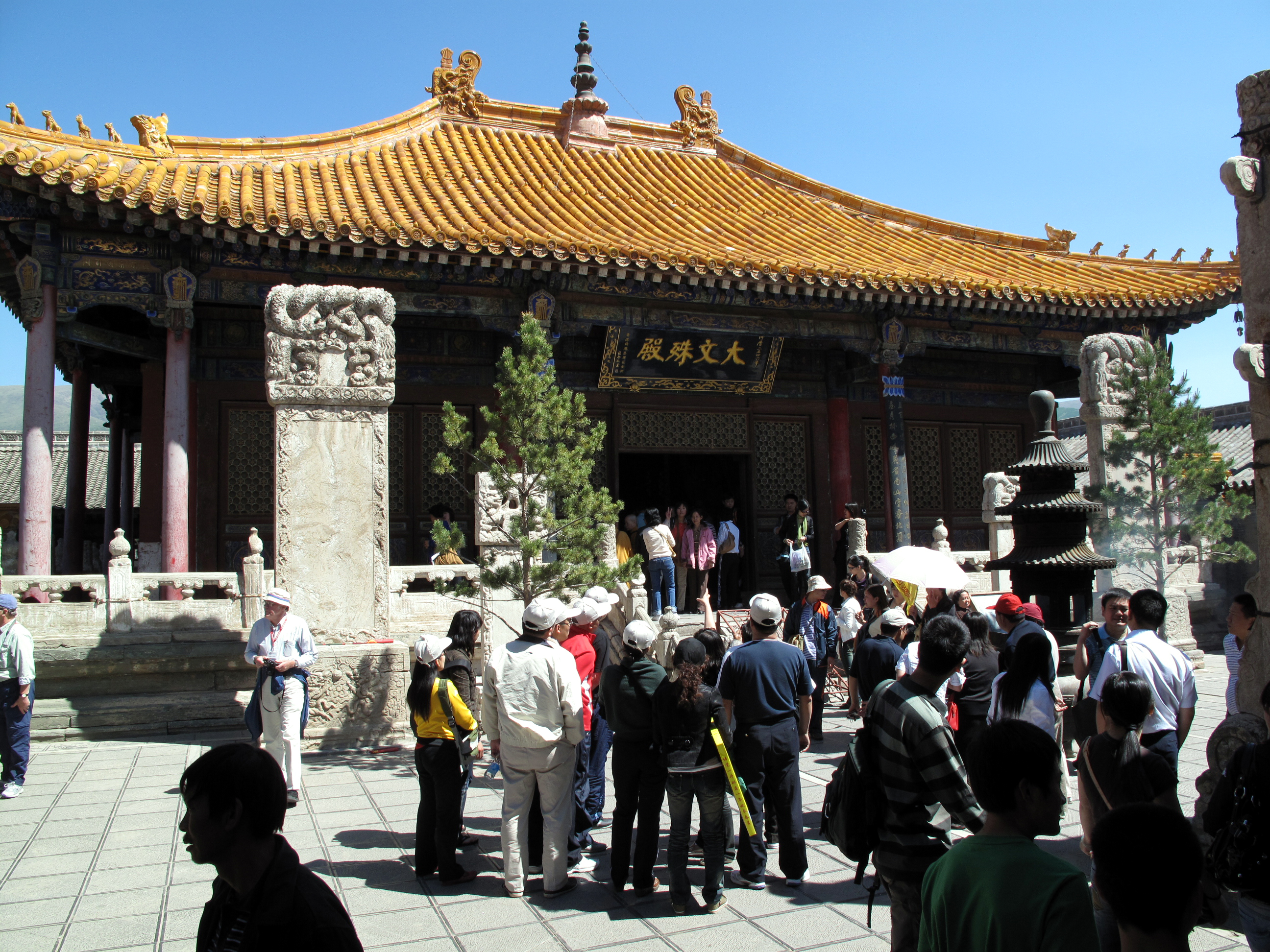 Pusading Si. Wutai Shan, Shanxi
Mount Wutai, originally sacred to Daoism, became one of the earliest places in China to embrace the new Buddhist faith. According to the Avatamsaka Sutra, an Indian monk had a vision of Bodhisattva Manjushri here in the first century AD, and the mountain has been regarded ever since as the abode of Manjushri. By the Northern Wei period, the mountain's temples were important enough to be represented on a mural at Dunhuang.
Pusading Si was especially favored by emperors Kangxi and Qianlong, who stayed here when making pilgrimages to Wutai. At that time, the ancient temple was rebuilt in Imperial Qing style, allowed the favor of Imperial yellow roof tiles, and put in charge of all other temples on the mountain. Its present buildings and layout therefore date to the Qing Dynasty.