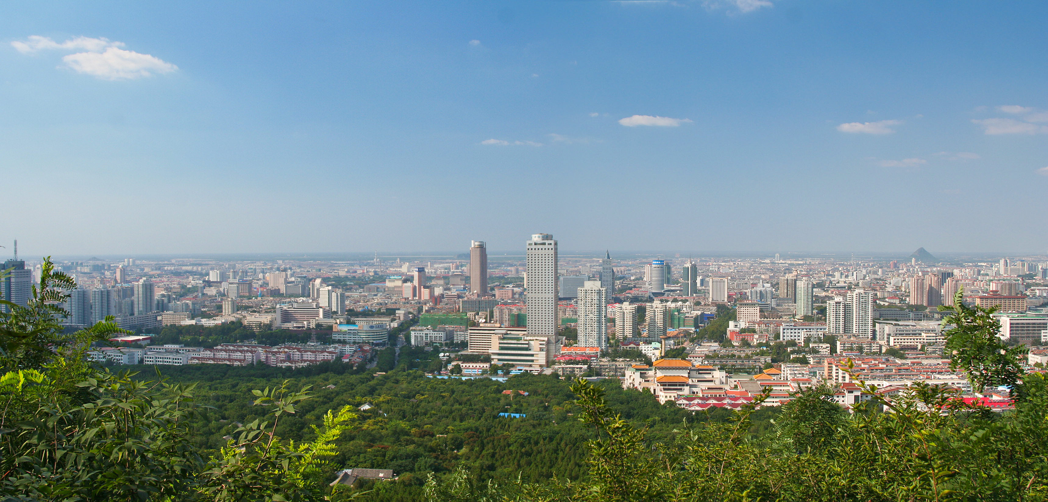 Photograph of the skyline of Jinan, Shandong, China from the Thousand Buddha Mountain to the south of the city.