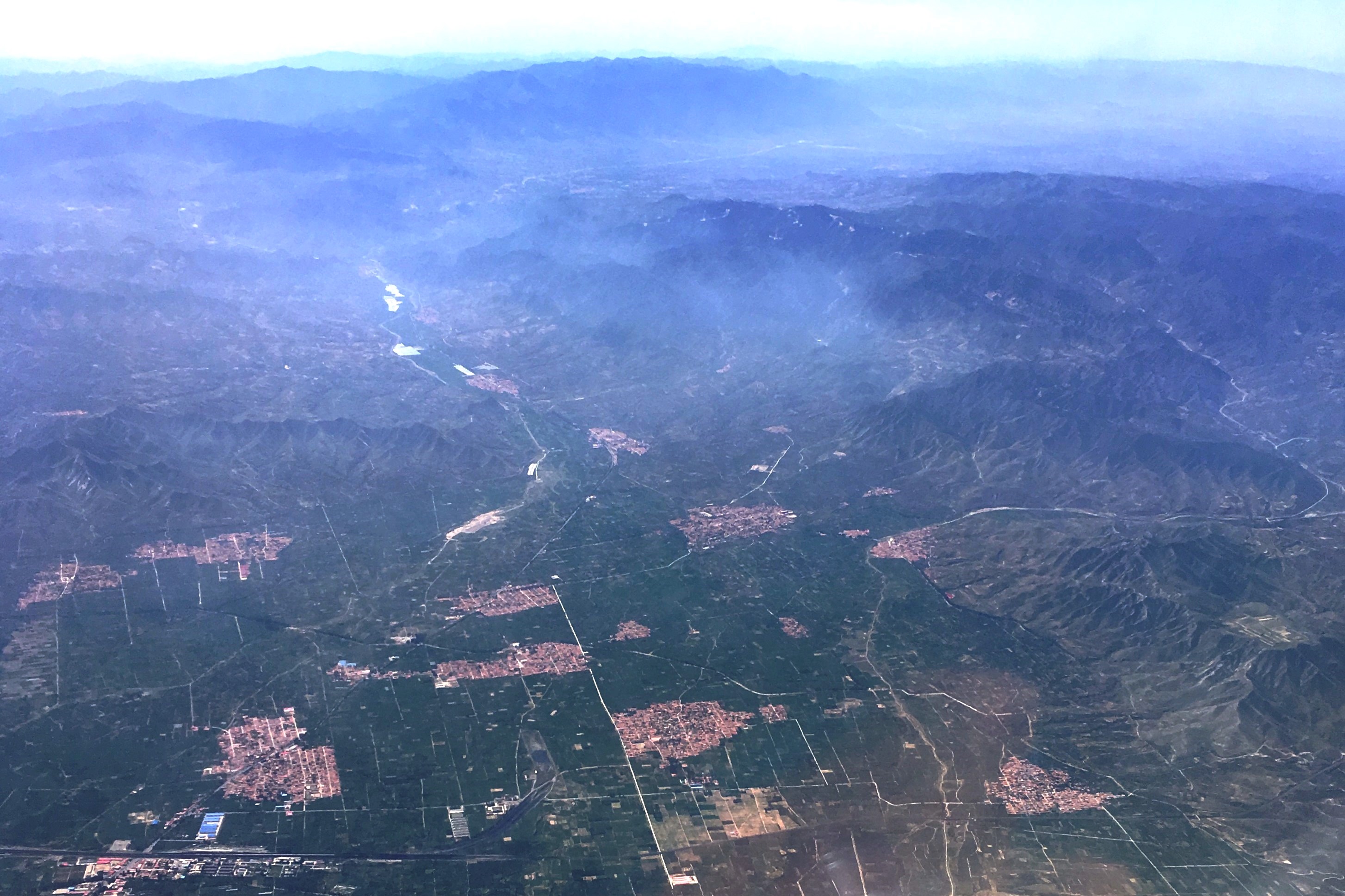 Aerial view from North towards South, of the Sanggan River South plain immediately south of Zhuolu city in the Zhangjiakou prefecture, Hebei province (China). The settlements are southern agricultural suburbs of Zhuolu city.