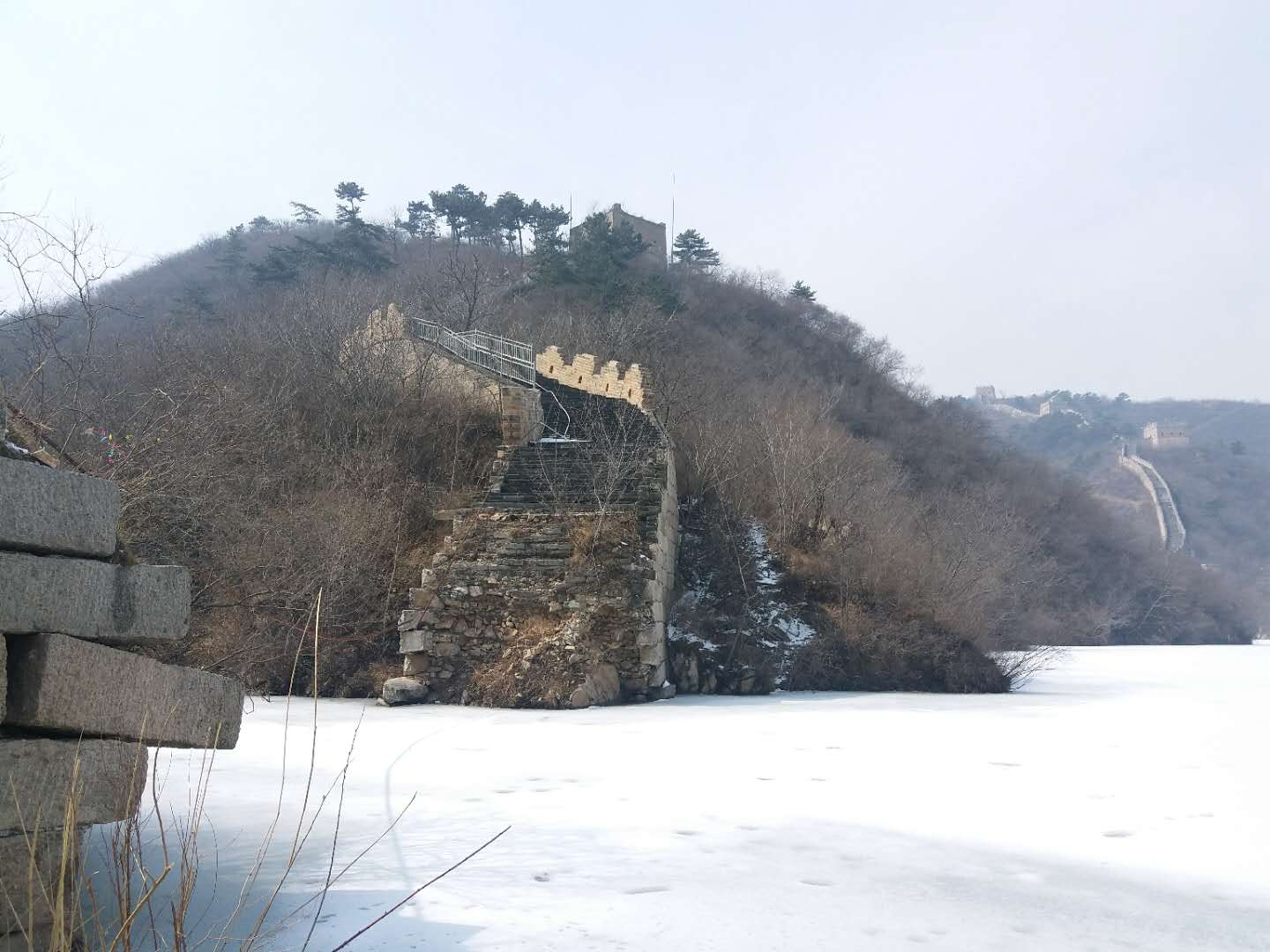 Submerged part of the Great Wall under lake water at the Lakeside Great Wall located at Huanghuacheng, Jiuduhe, Huairou District, Beijing, China in March 2018. The lake is frozen.