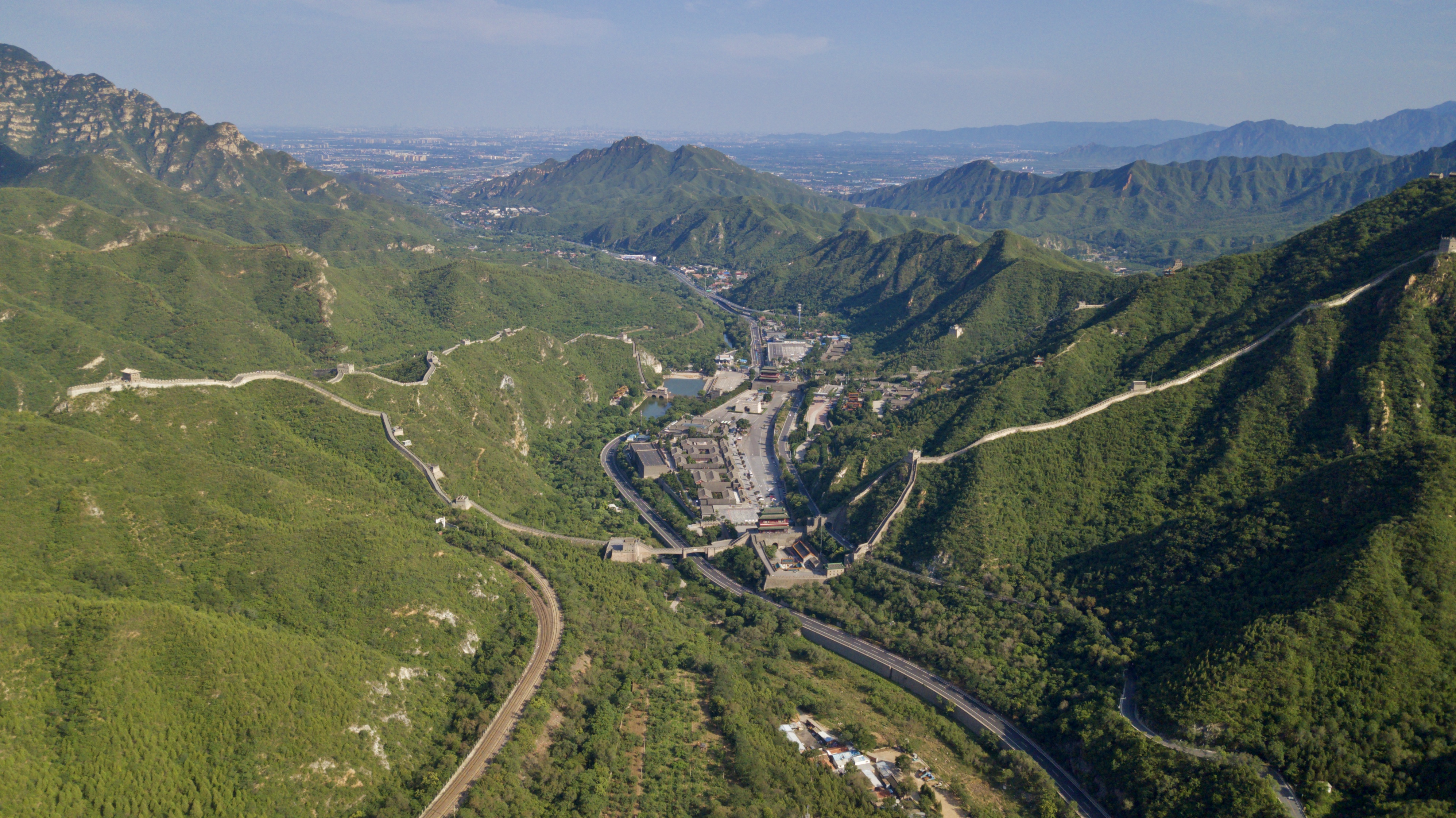 Juyong Pass panorama from the north. The Great Wall passes through. Juyong Pass is an important mountain pass located in the north of Beijing where the Beijing-Zhangjiakou Railway(1909) and G6 Expressway, S216 province way pass through.