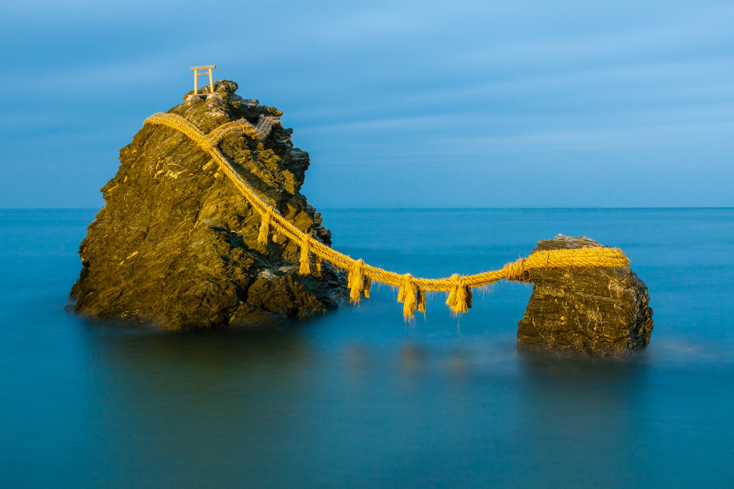 A picture of Meoto Iwa rocks at dusk, with some high tide. Long exposure on a tripod.