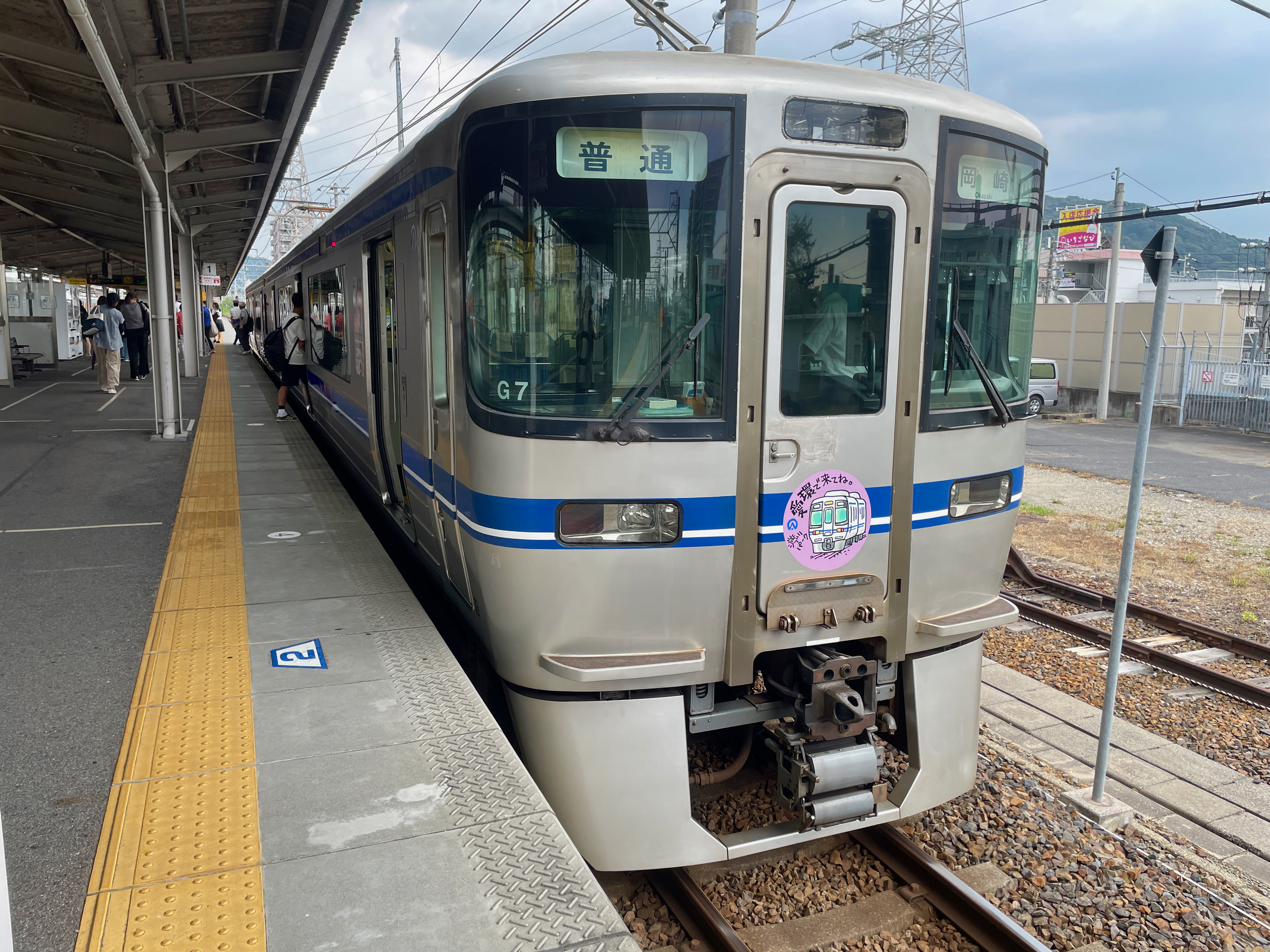 高蔵寺駅にとまる愛知環状線の電車。ヘッドマークに「ジブリパーク愛環で来てね」と書いてある。