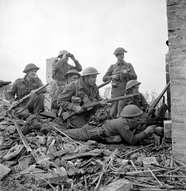 Lieutenant I. Macdonald (with binoculars) of The 48th Highlanders of Canada preparing to give the order to attack to infantrymen of his platoon, San Leonardo di Ortona, Italy.  Infantrymen L-R: Sergeant J.T. Cooney, Privates A.R. Downie, O.E. Bernier, G.R. Young, Corporal T. Fereday and Private S.L. Hart.