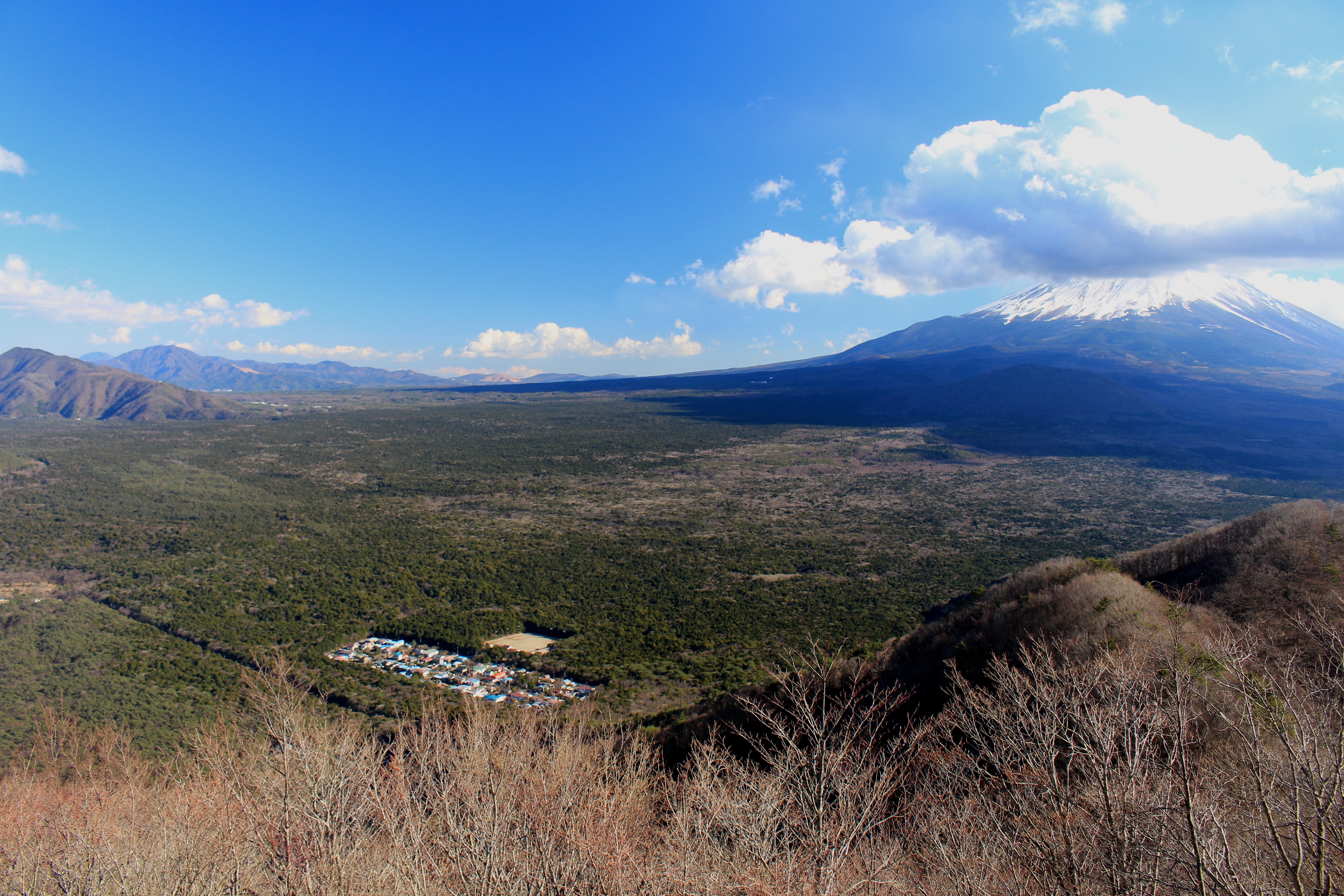Aokigahara, Mount Ashiwada and Mount Fuji with clouds seen from Panoramadai (Misaka Mountains) in Yamanashi Prefectre, Japan.