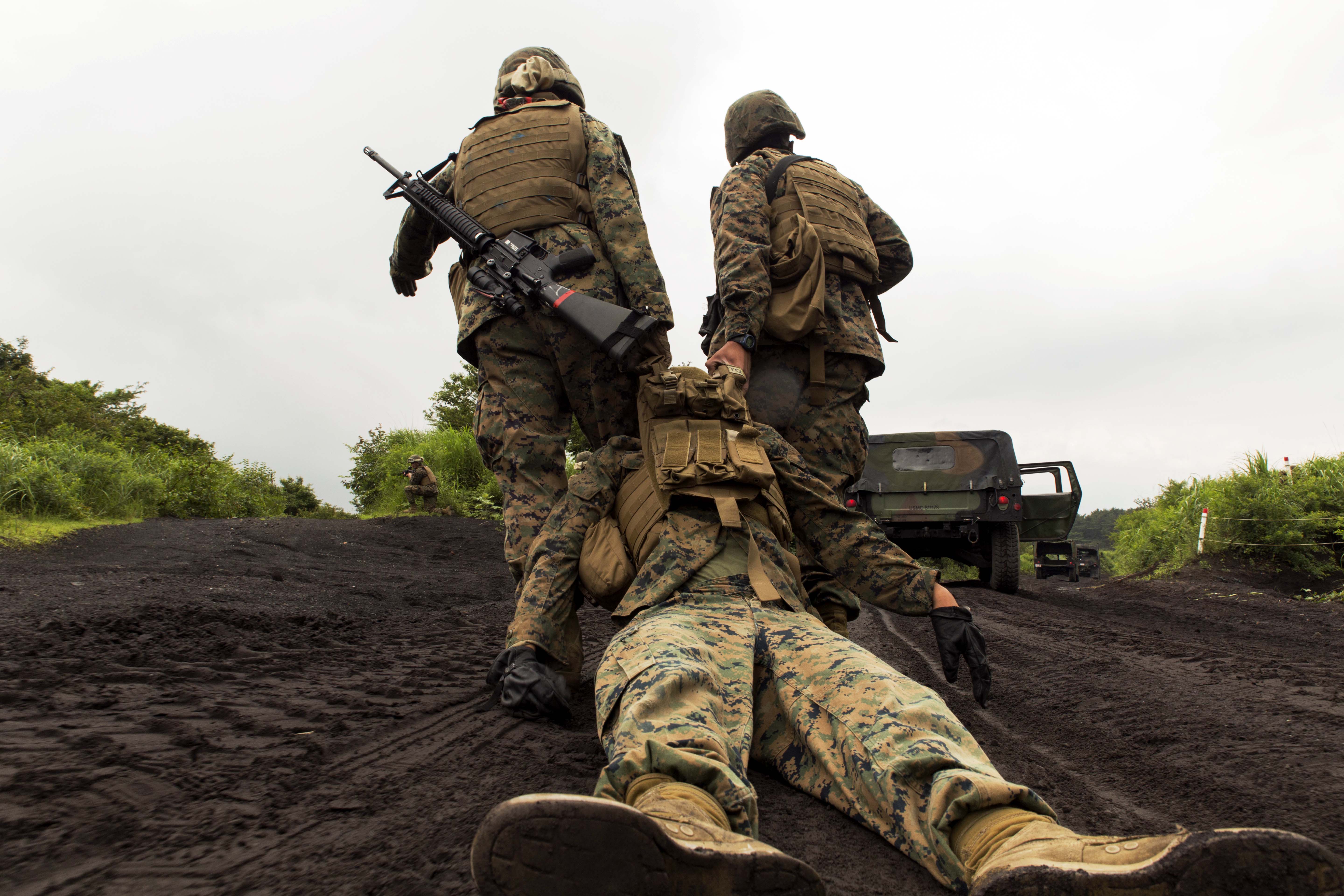 Marines with Combat Logistics Company 36 drag a casualty of an Improvised Explosive Device during Exercise Dragon Fire 2014 at Combined Arms Training Center Camp Fuji, Japan, July 19. While just a training event, Sgt. Paul Faucheux, an explosive ordnance disposal technician with Marine Corps Installations Pacific, said it provided junior Marines an introduction to IED strikes, allowed noncommissioned officers to teach, and challenged their combat leadership in countering IED strikes.

(U.S. Marine Corps photo by Cpl. Antonio Rubio/Released)