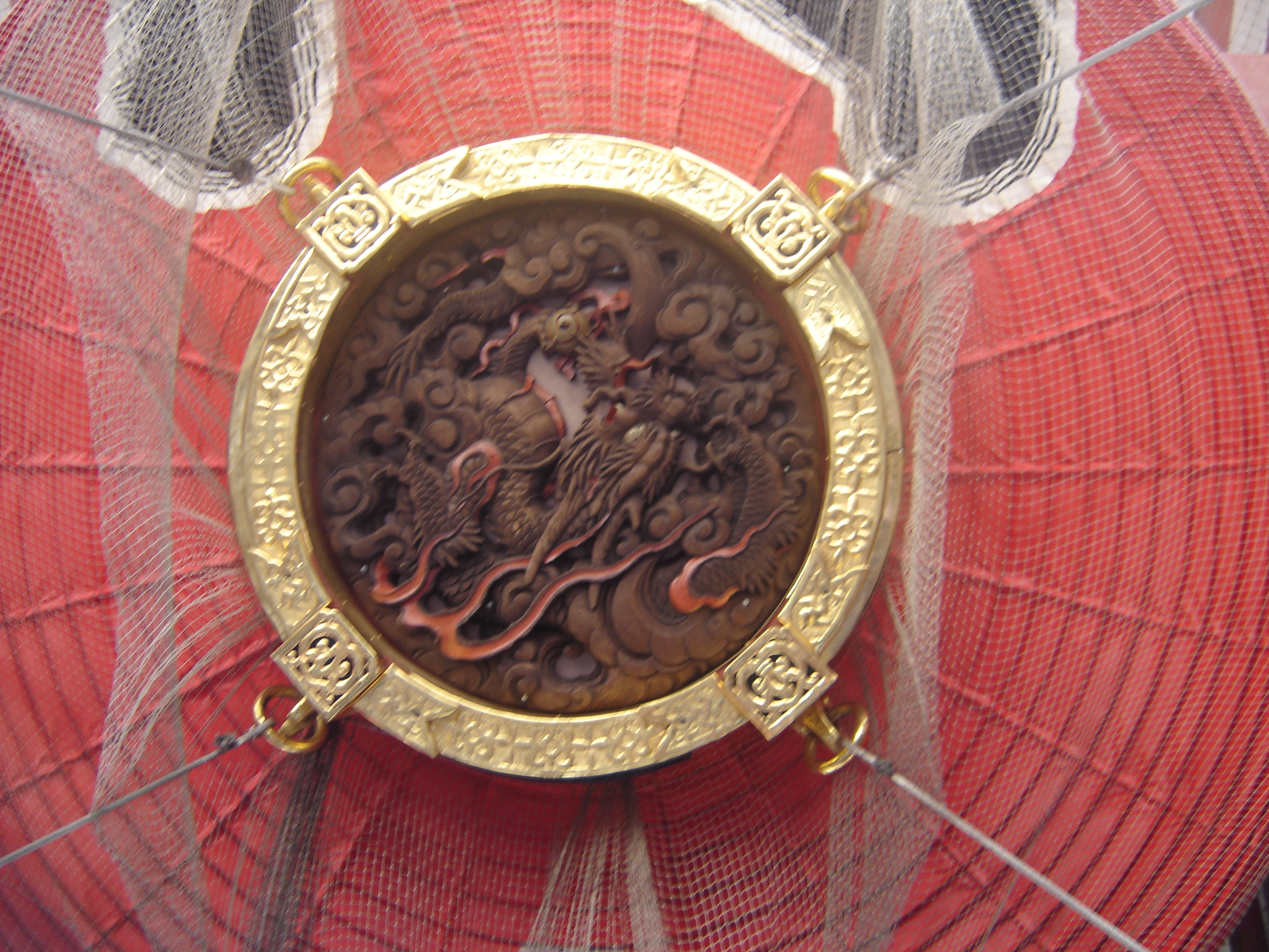 The wooden carving of a dragon on the bottom of the great red lantern on the Kaminarimon.