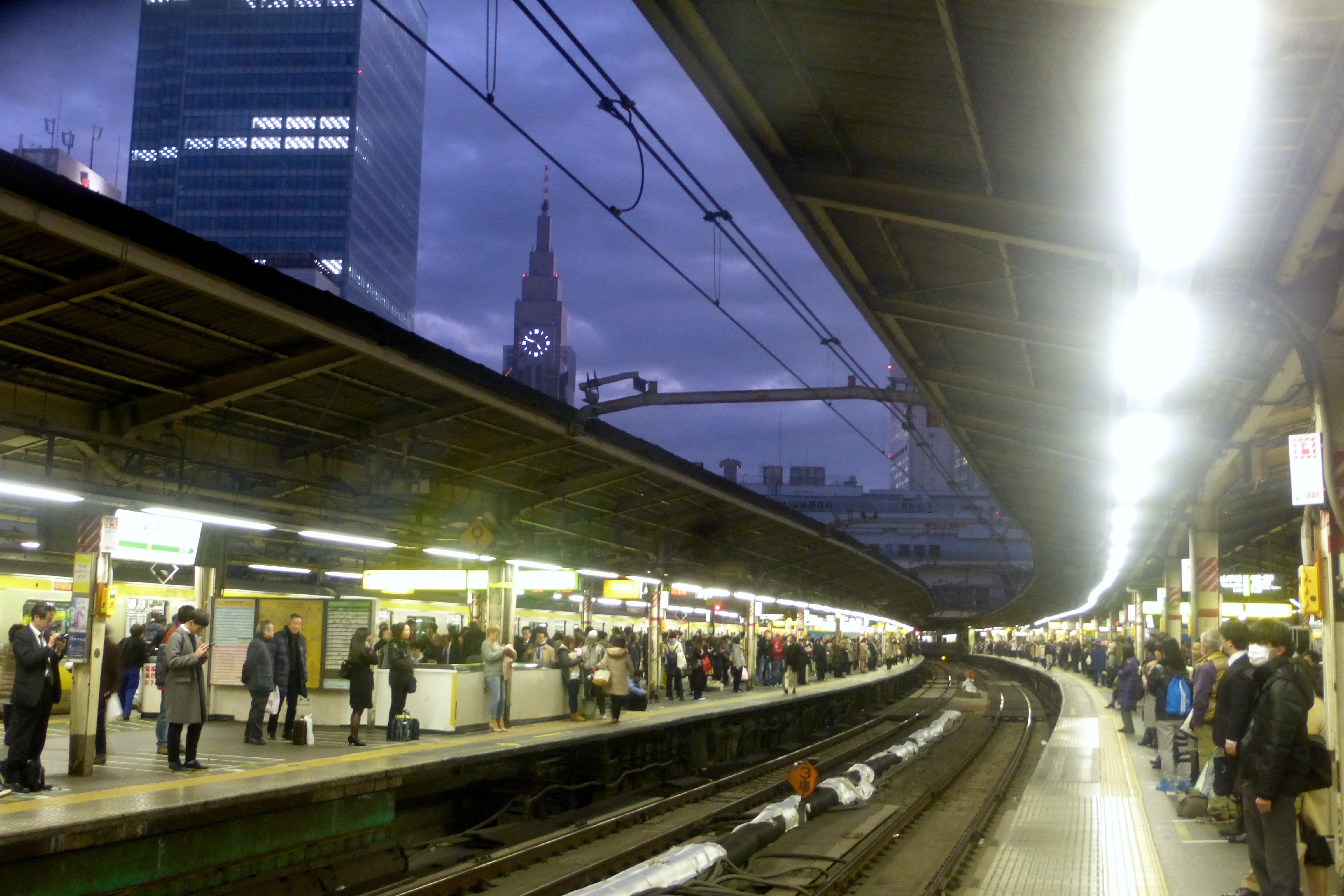 NTT DoCoMo Yoyogi Building from Shinjuku Station platforms at dusk