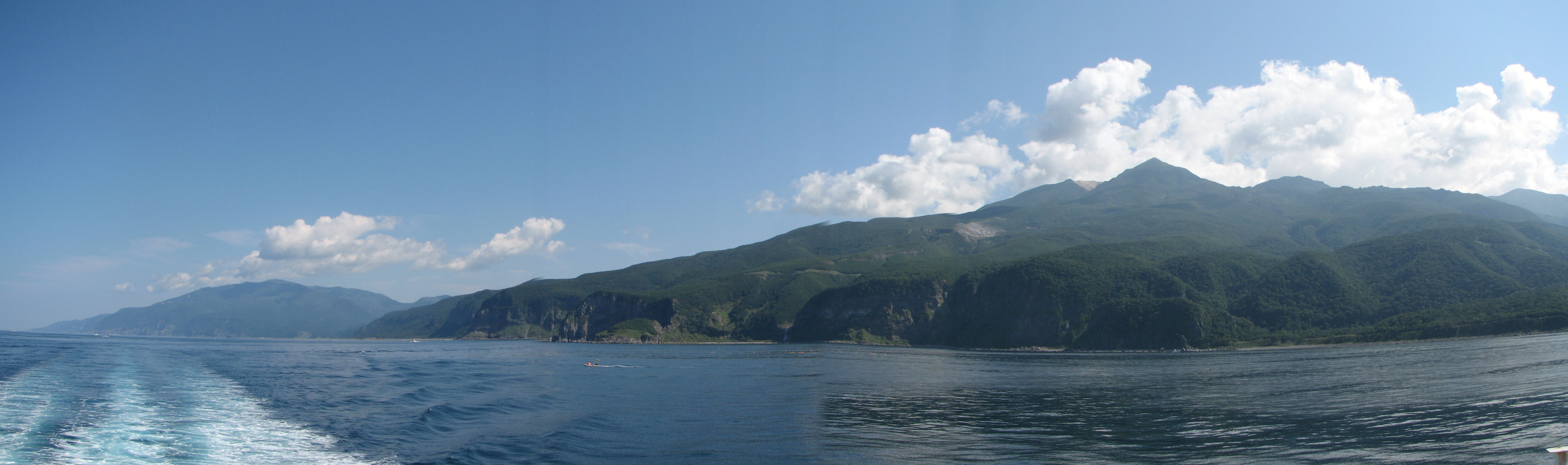 View of Shiretoko National Park. Mount Iō (right) and Mount Shiretoko (far left) seen from Sea of Okhotsk. Six seperate photos wer taken and stiched together with a software.