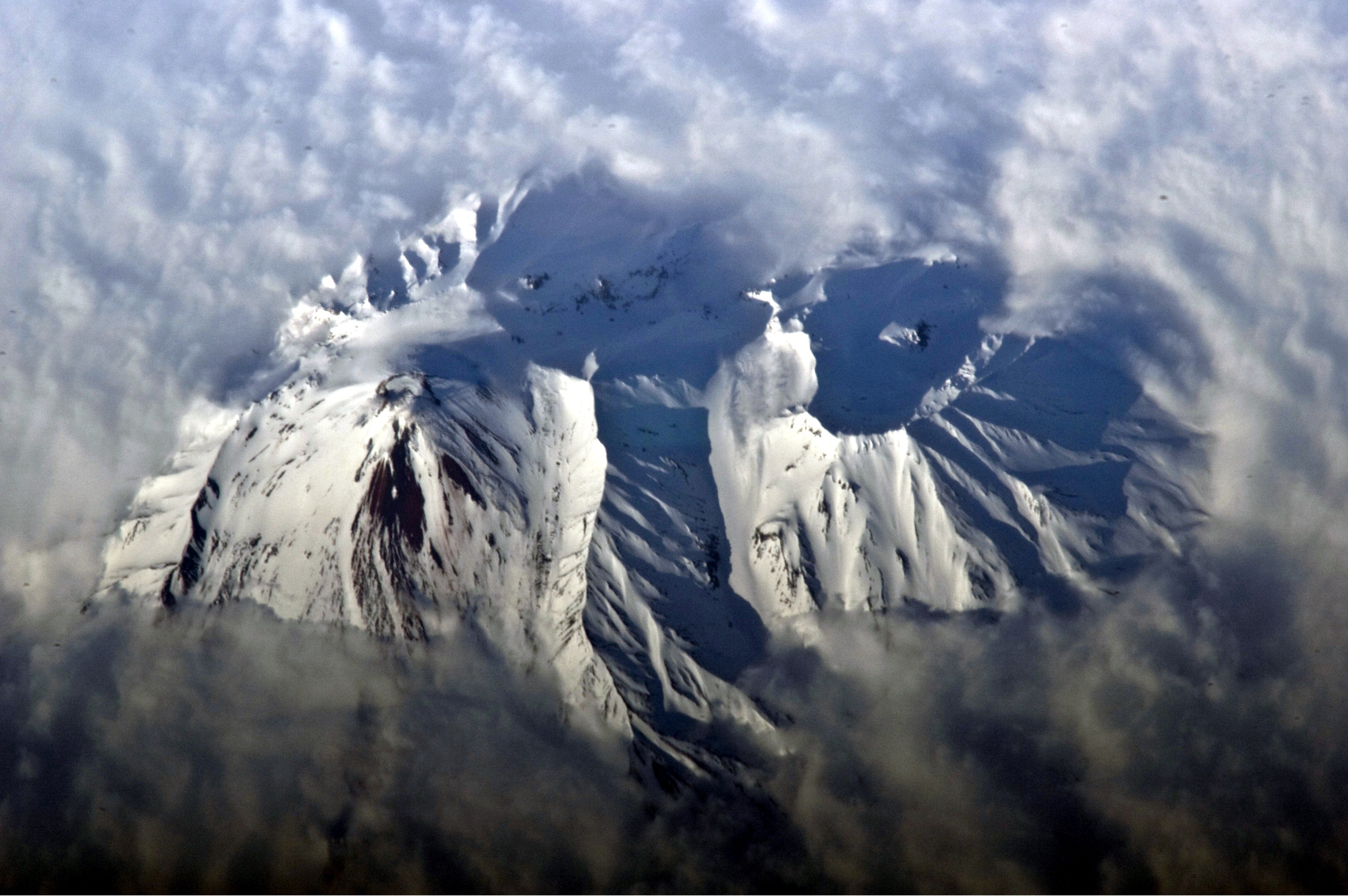 This astronaut photograph highlights the summit crater and snow-covered slopes of the Avachinsky stratovolcano as it pokes above a surrounding cloud deck. To the southeast (image right), the large breached crater of Kozelsky Volcano is also visible above the clouds.
Image acquired with a Nikon D2Xs digital camera using an 800 mm lens, and is provided by the ISS Crew Earth Observations experiment and Image Science &amp; Analysis Laboratory, Johnson Space Center.