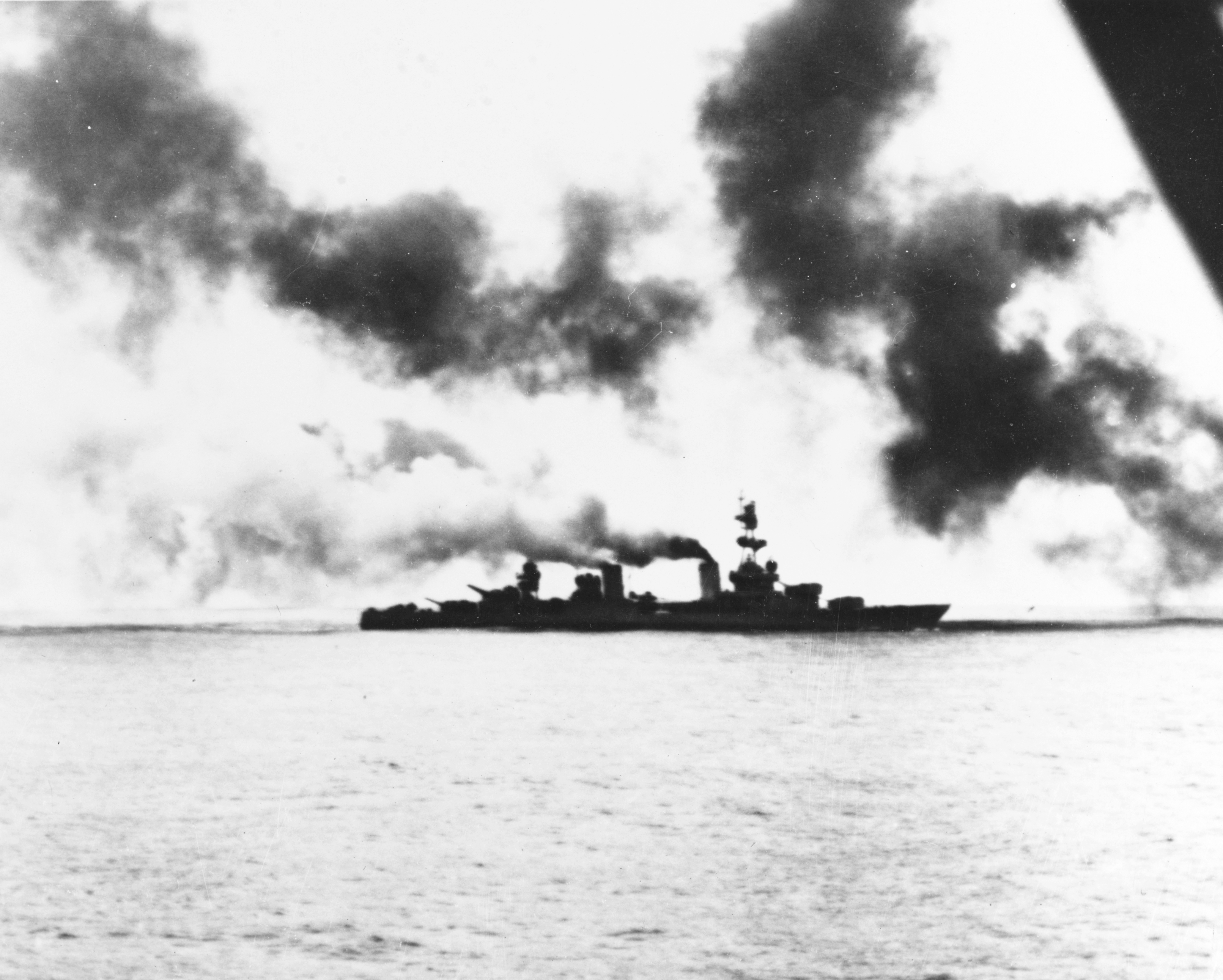 The U.S. Navy heavy cruiser USS Salt Lake City (CA-25) in action during the Battle of the Komandorski Islands on 26 March 1943, with an enemy salvo landing astern.