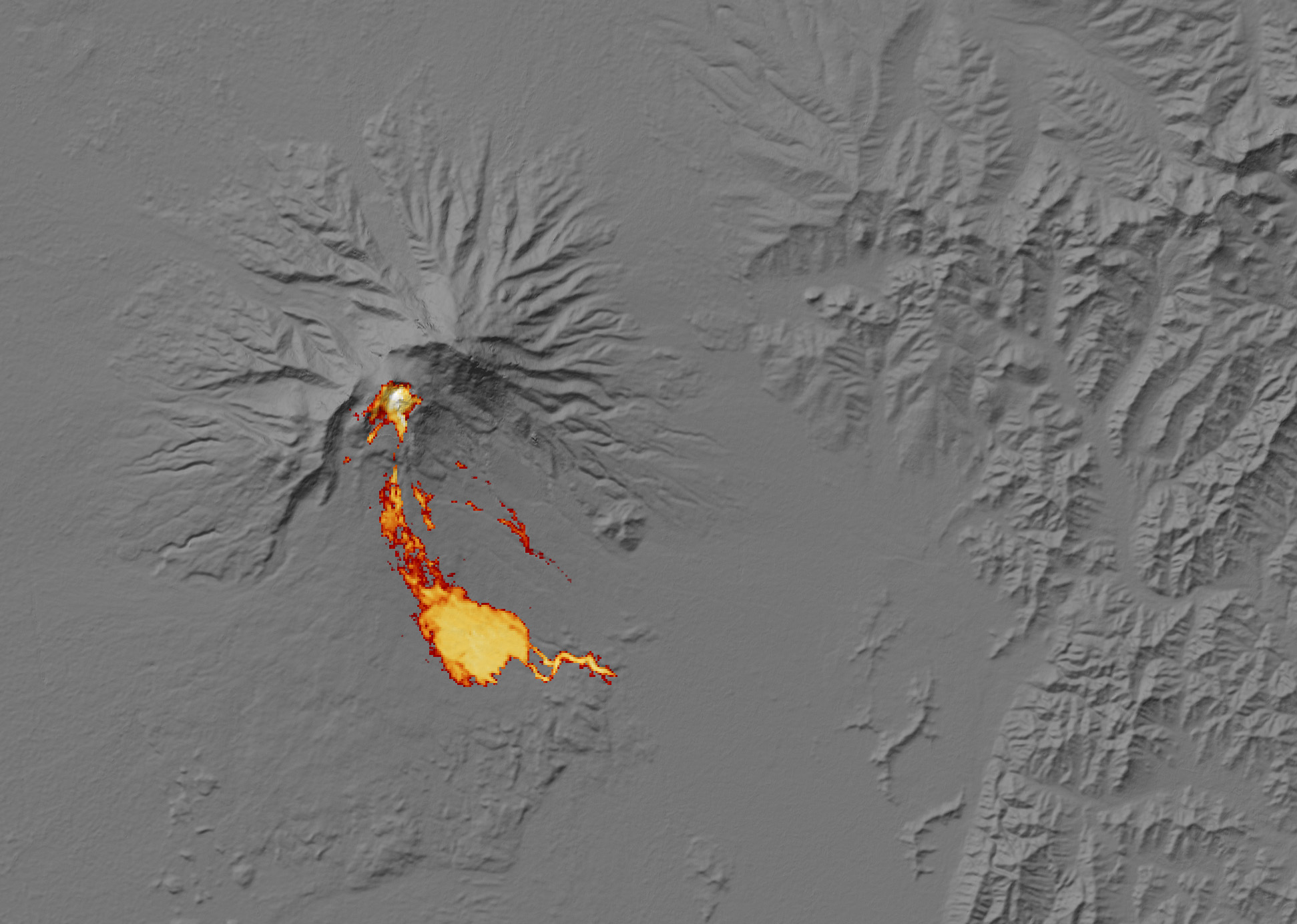 This image shows the heat signature of a pyroclastic flow on Shiveluch as measured in thermal infrared light. The white area at the lava dome is very hot, while the red areas on the edge of the flow are just warmer than the surrounding snow.