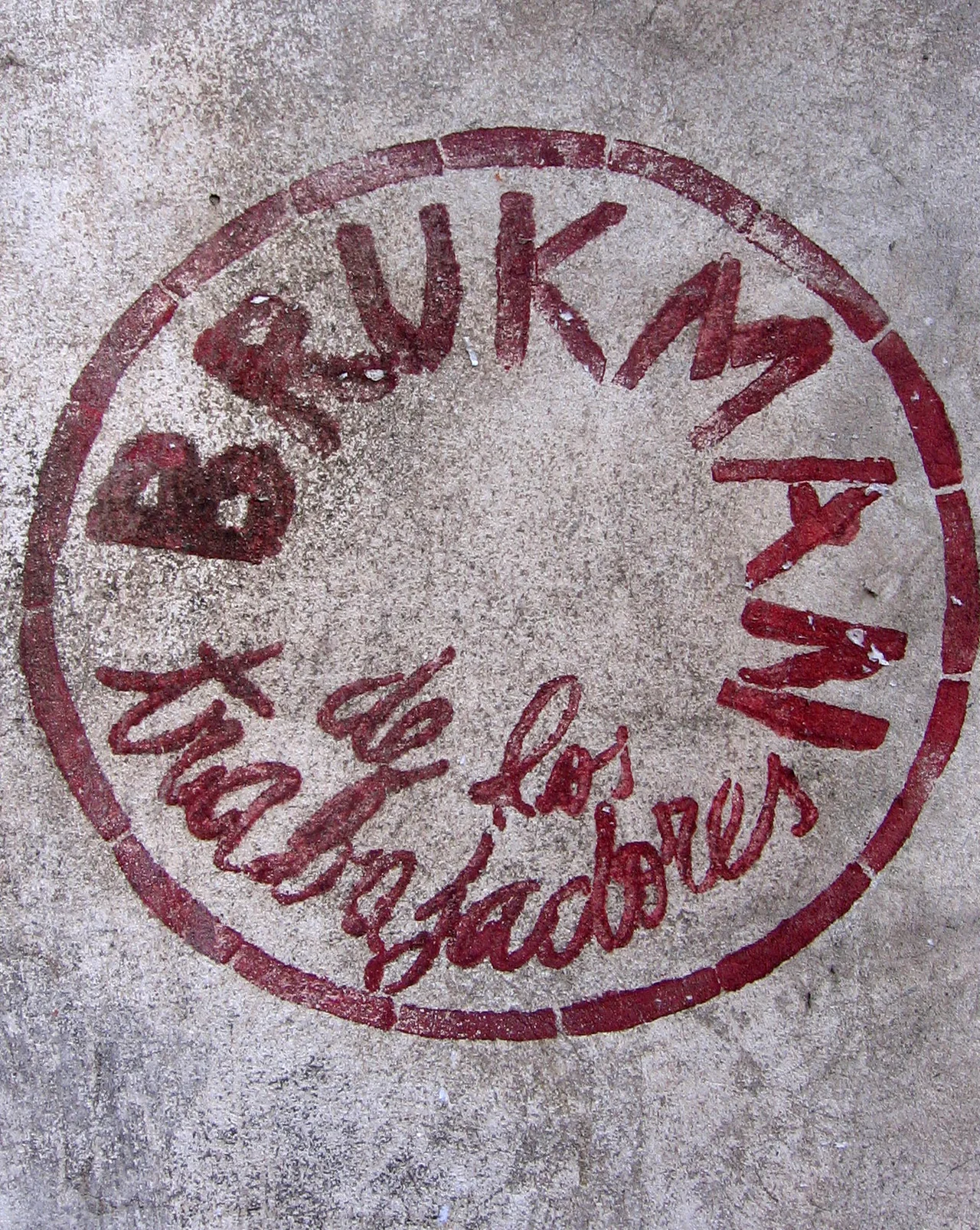 Strenciled graffiti near Brukman factory, which reads "Brukman belongs to the workers." Stencil by Taller Popular de Serigrafía.