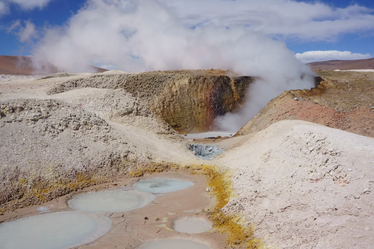 Sol de Mañana (Morning Sun in Spanish) is a geothermal field in Sur Lípez Province, Potosi Department, southwestern Bolivia. The field extends over 10 square kilometres (2,500 acres) and is between 4,800 metres (15,700 ft) and 5,000 metres (16,000 ft) high. The area, characterized by intense volcanic activity, with sulphur spring fields and mud lakes, has indeed no geysers but rather holes that emit pressurized steam up to 50 metres (160 ft) high.