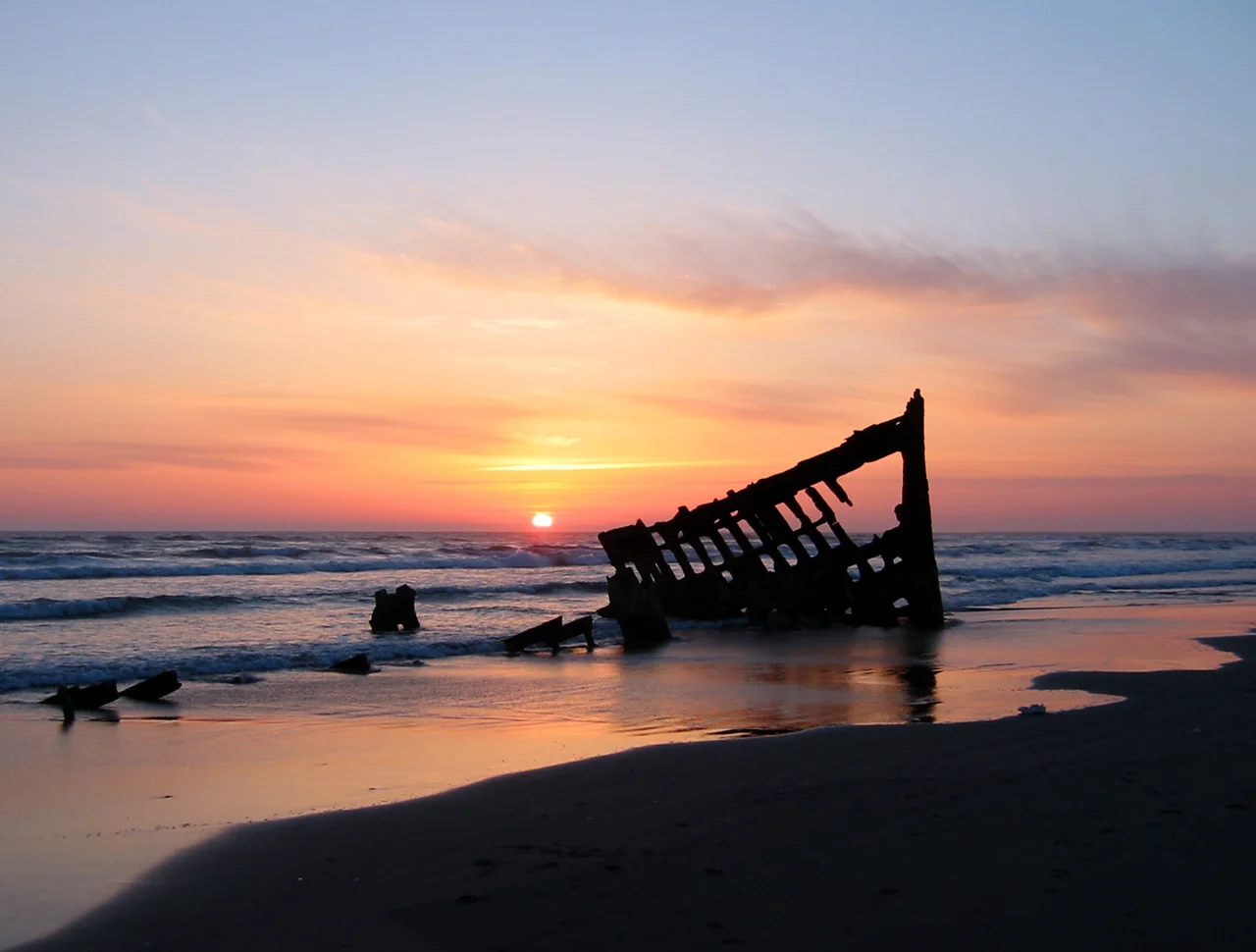 The wreck of the Peter Iredale in the Fort Stevens State Park, Oregon, USA, at sunset. Ran aground in 1906.
