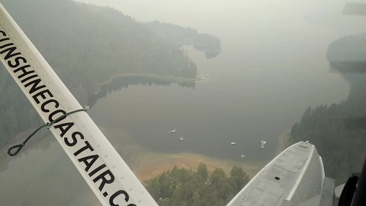 Storm Bay British Columbia as seen from the air through a haze of wildfire smoke.