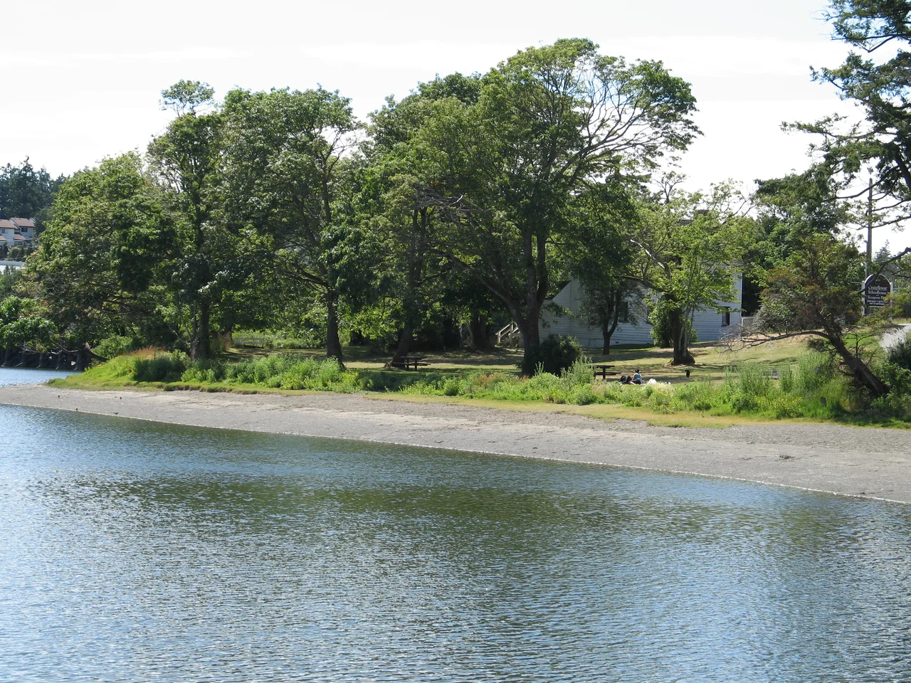 A shot of Kosapsom Park, including Craigflower schoolhouse, taken on approach along the Gorge Waterway from the east. The Craigflower manor house is location 200 metres to the southwest on the opposite side of the Gorge waterway.