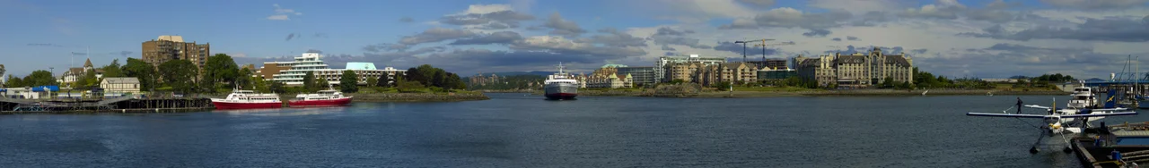 Panorama of the landmarks on the Inner Harbour, Victoria, British Columbia, Canada.  The major buildings, from left to right, are The Fairmont Empress, Royal British Columbia Museum, British Columbia Parliament Buildings, Pacific Undersea Gardens (white building floating on water), the Royal London Wax Museum (originally the Canadian Pacific Railway Steamship Terminal, also by Francis Rattenbury), Grand Pacific Hotel, the ferry terminal for Black Ball ferries (MV Coho).