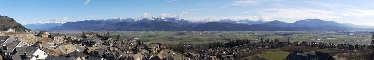View of Abbotsford, BC and Sumas Prairie looking southeast from Eagle Mountain (Lower Sumas Mountain), Abbotsford, BC, Canada. Observe Mount Baker, partially obscured by clouds, in the distance. Eagle Mountain is not to be confused with Eagle Mountain in Coquitlam, BC.