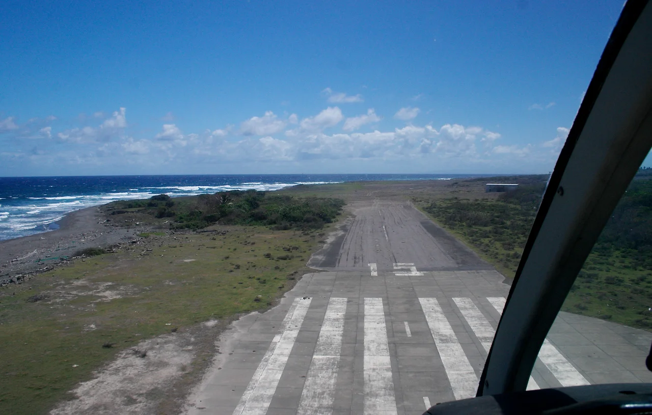 The remains of runway 15 of the abandoned W.H. Bramble International Airport, Montserrat, as seen from helicopter.