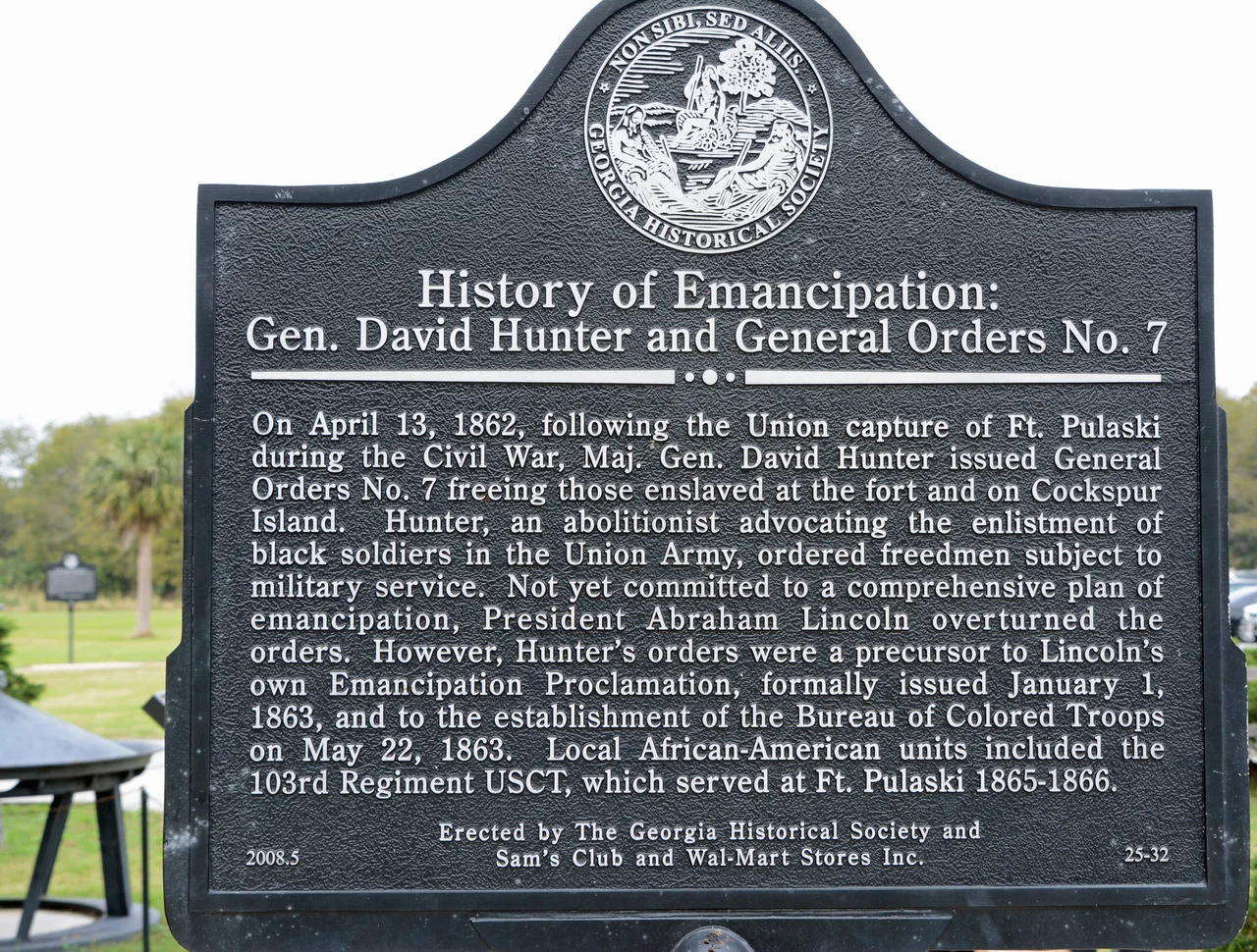 Historical marker at Fort Pulaski, Georgia, US; about General Orders No. 7 for emancipation, which was reversed by President Lincoln. The original cap of the Cockspur Island Lighthouse is seen in the bottom left corner. The marker was erected by the Georgia Historical Society in 2008.
