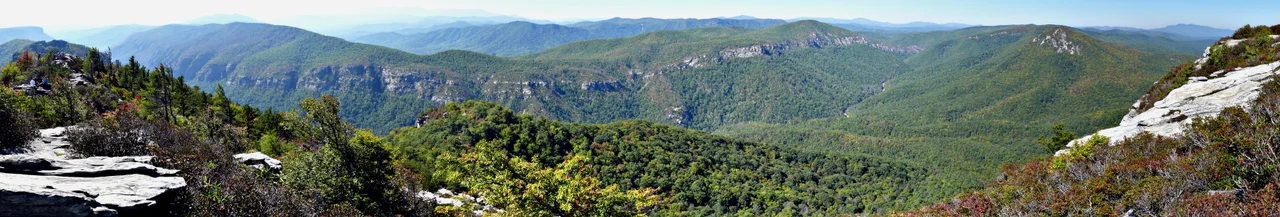 Looking west across the Linville Gorge from near the summit of Table Rock. To the left (south) you can see The Chimneys with Shortoff Mountain farther out near the horizon. To the right (north) the rocky peak is Hawksbill Mountain, with Grandfather Mountain looming in the distance. Panoramic image compiled with Autostitch from 20 individual photographs, taken with a Panasonic Lumix DMC-FZ50 mounted to a Panosaurus tripod head.