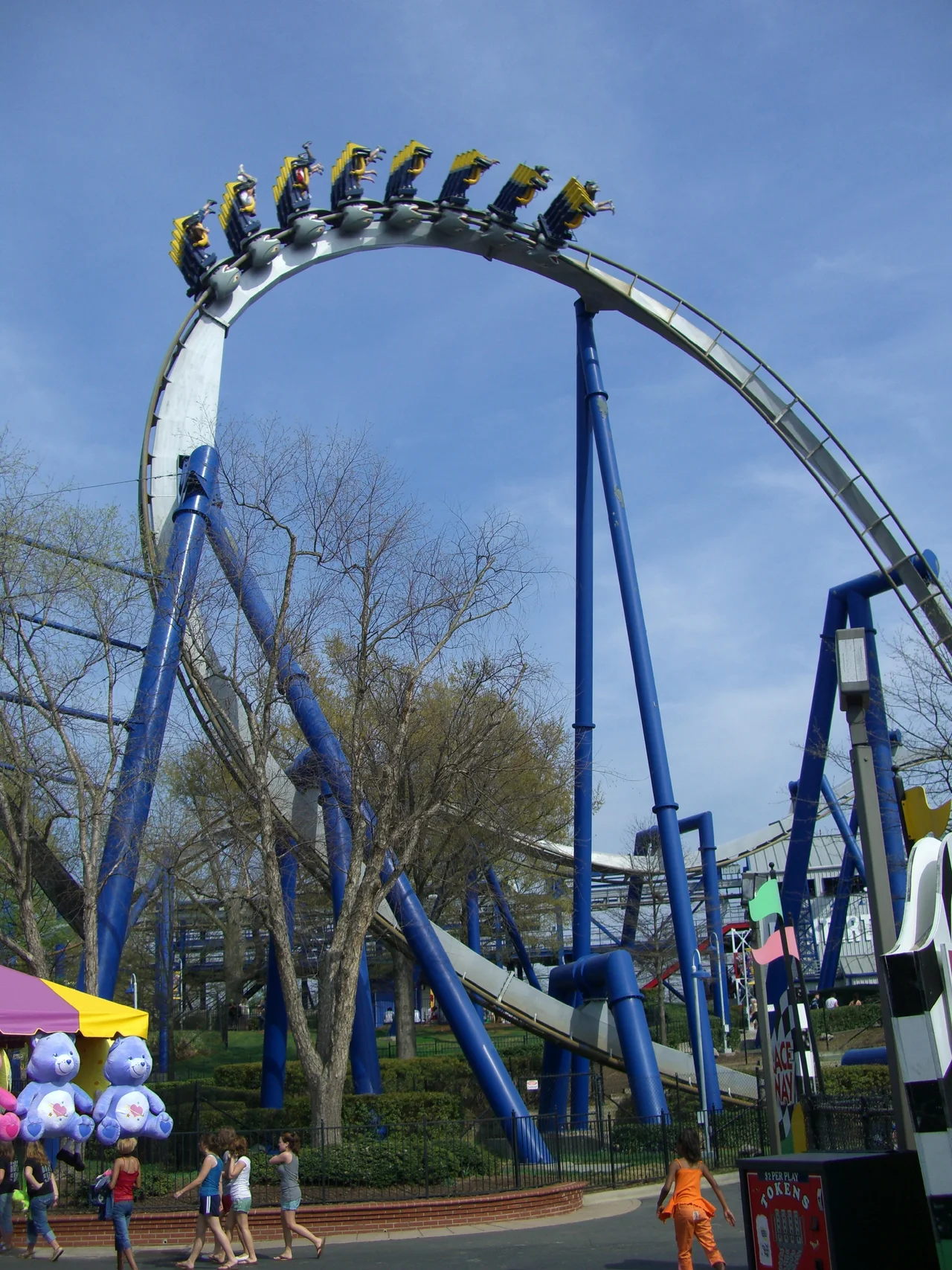 Top Gun: The Jet Coaster's yellow train maneuvering its second inversion, the immelmann.